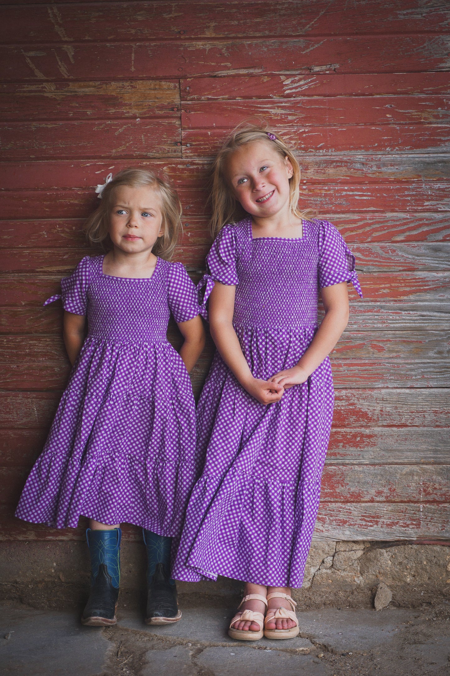 Young girls wearing modest purple dresses