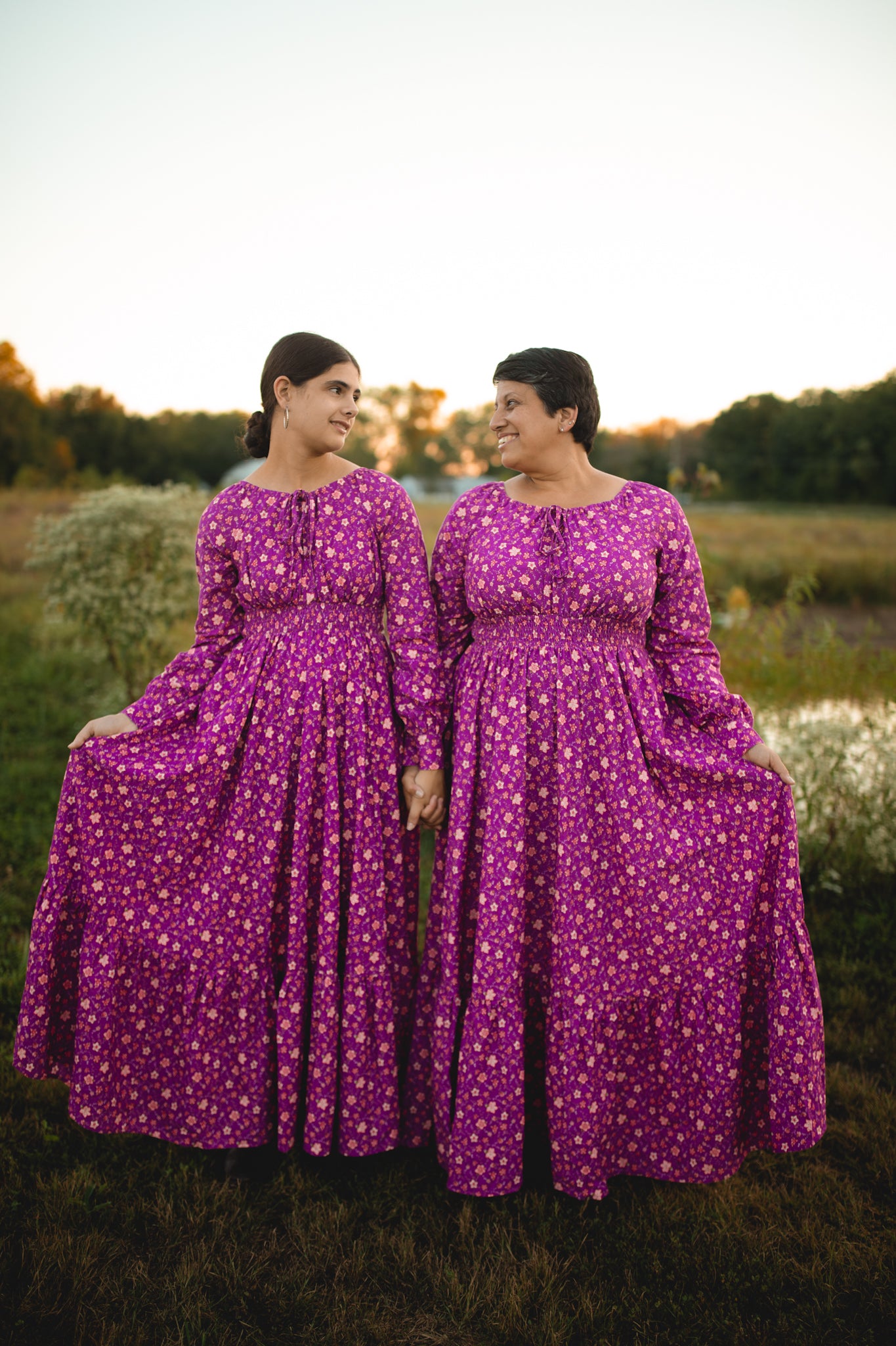 Two women in modest purple nursing dresses