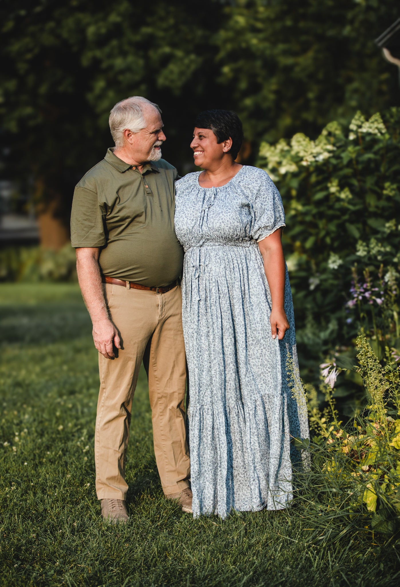 woman in a modest blue nursing dress with her husband