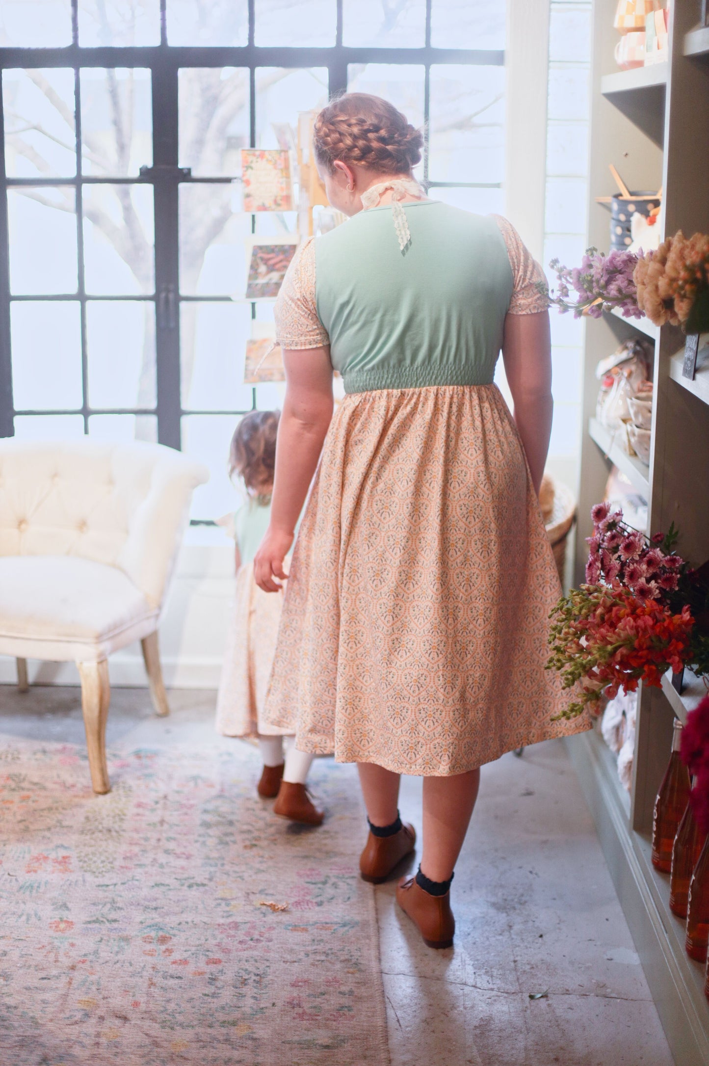 A woman wearing a vintage style modest nursing dress.