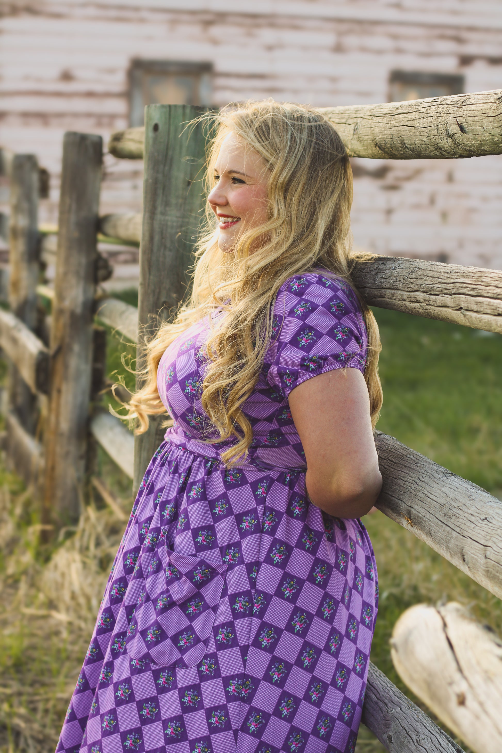 Woman in a purple checkered modest nursing dress.