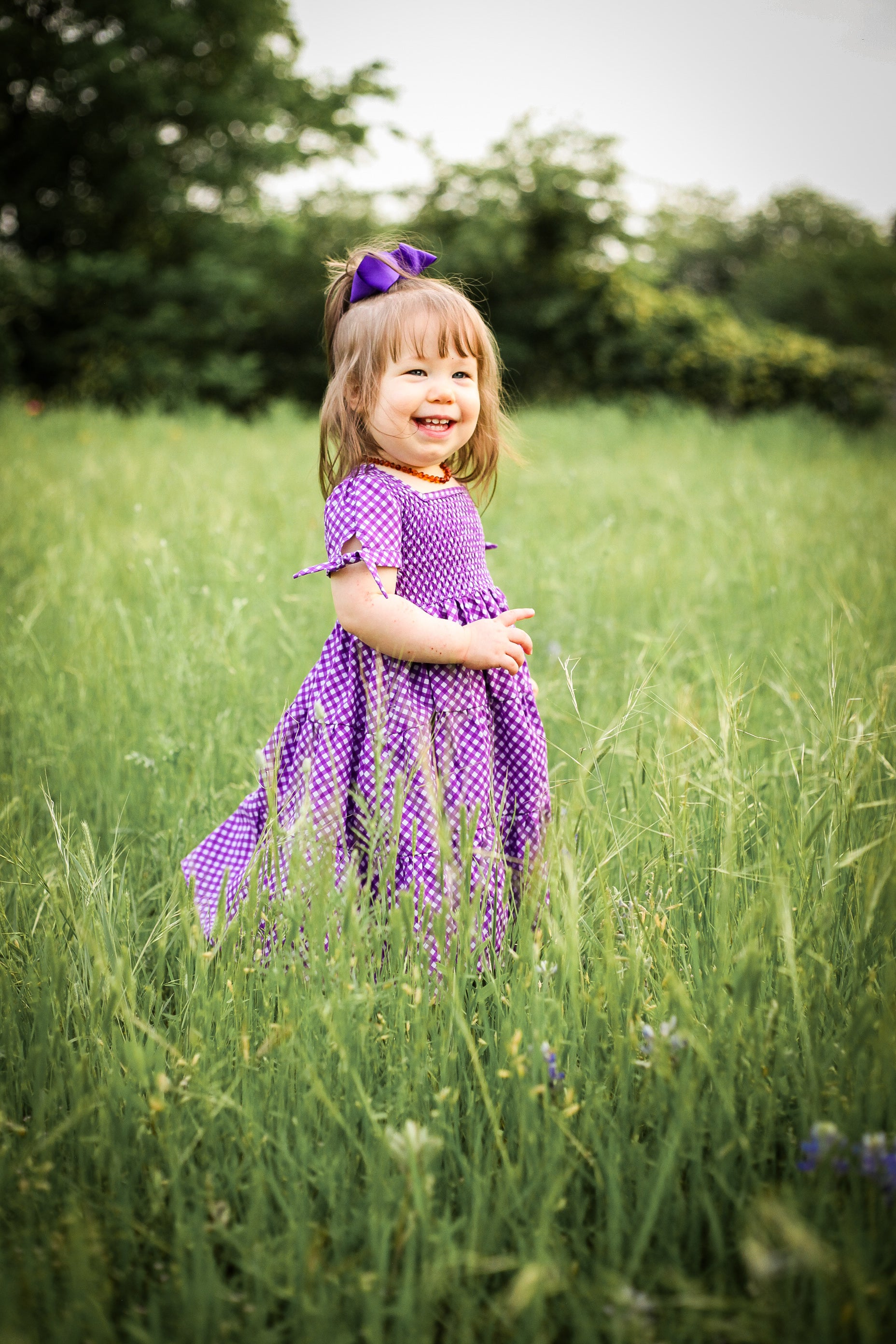 Young girl wearing a modest purple dress