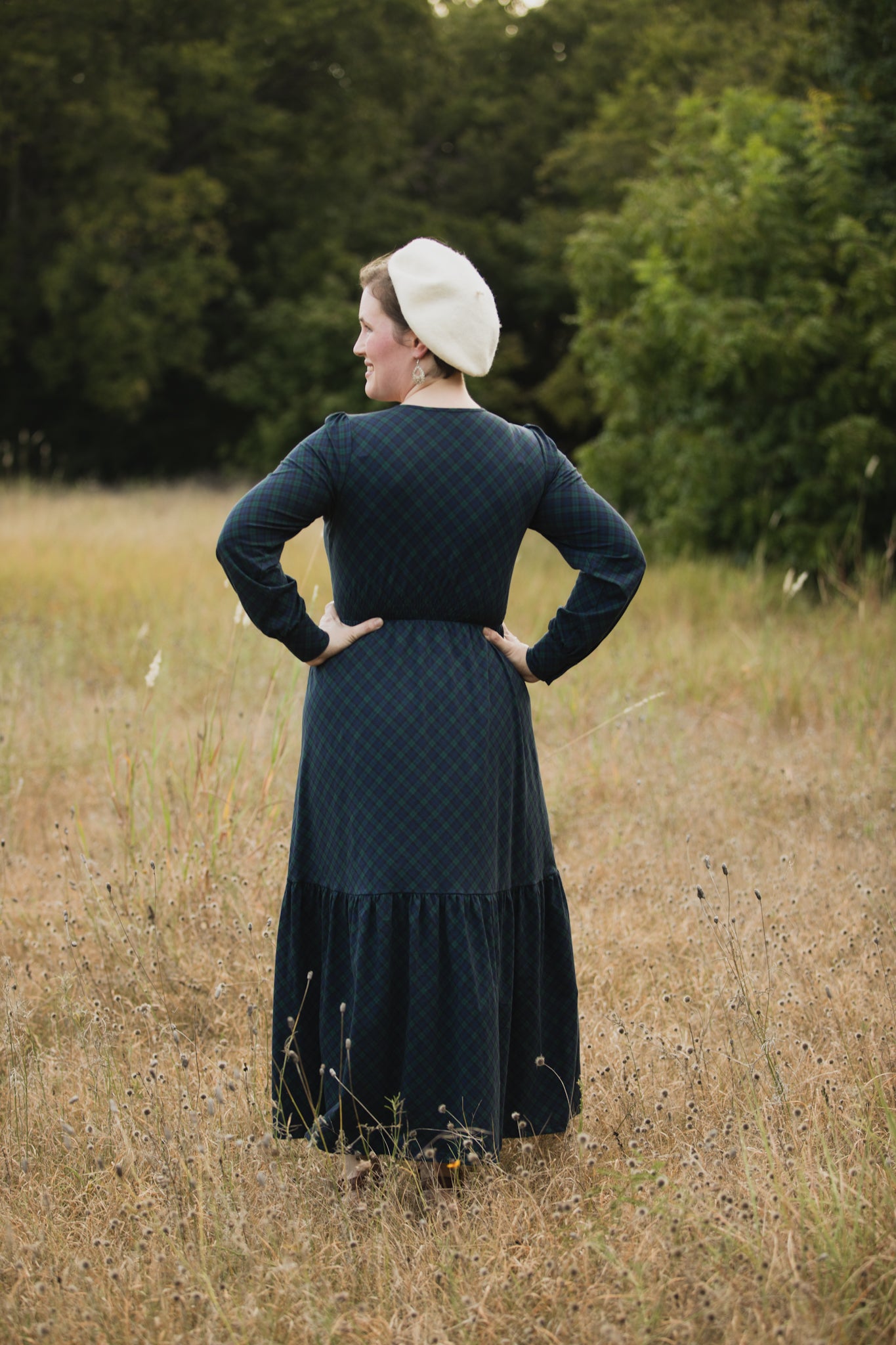 Woman in modest nursing dress white bonnet field