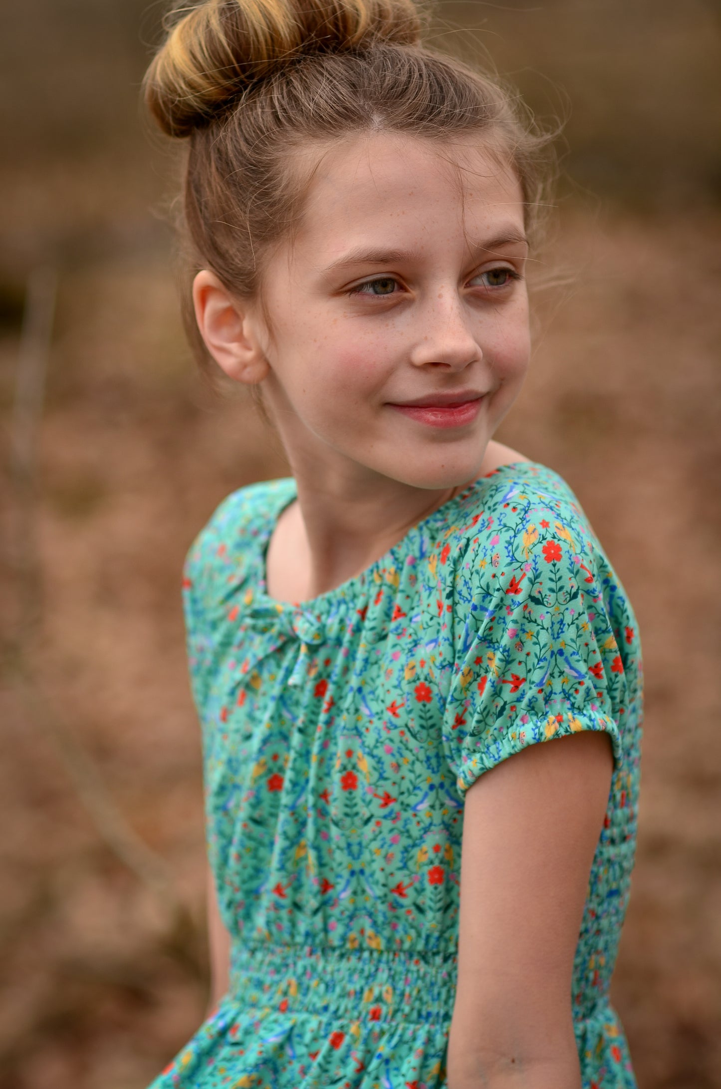 Young girl wearing a modest green dress