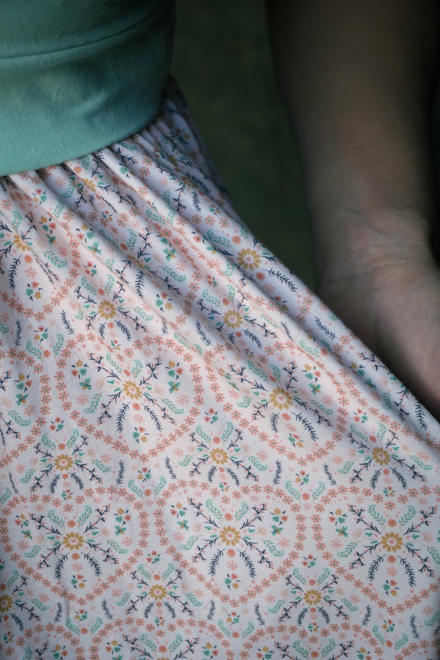 A woman wearing a vintage style modest nursing dress.