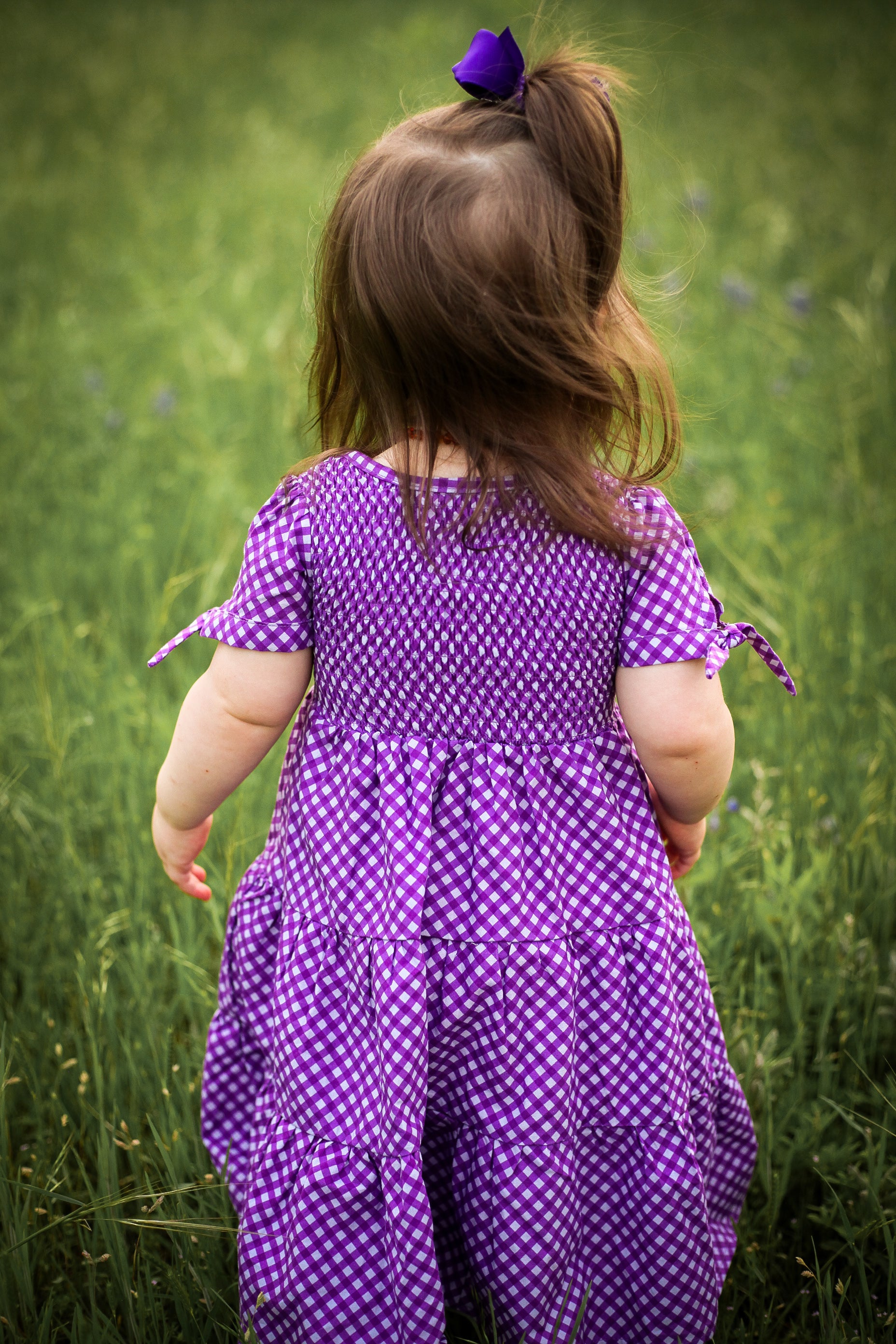Young girl wearing a modest purple dress
