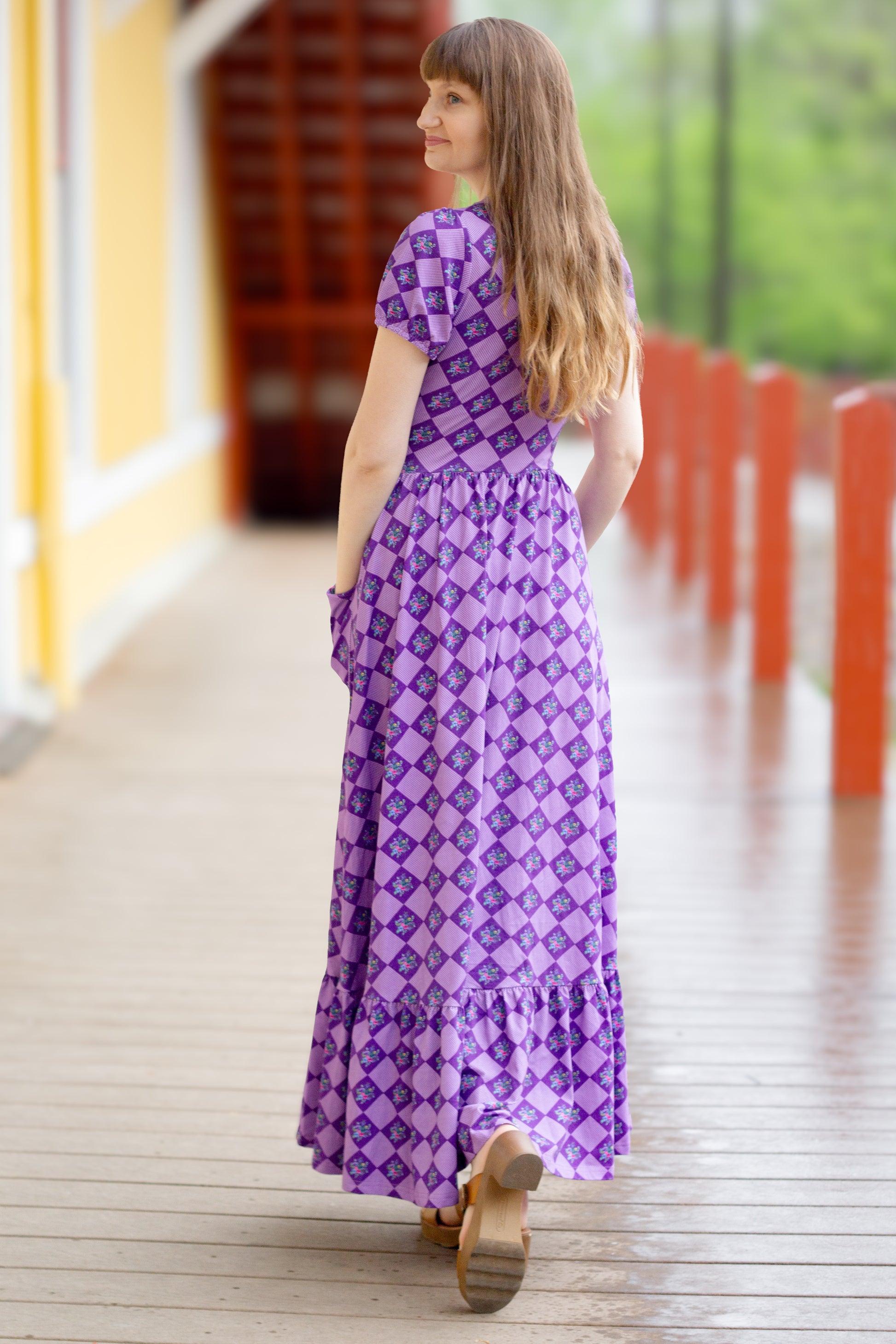 woman wearing patterned purple modest nursing dress