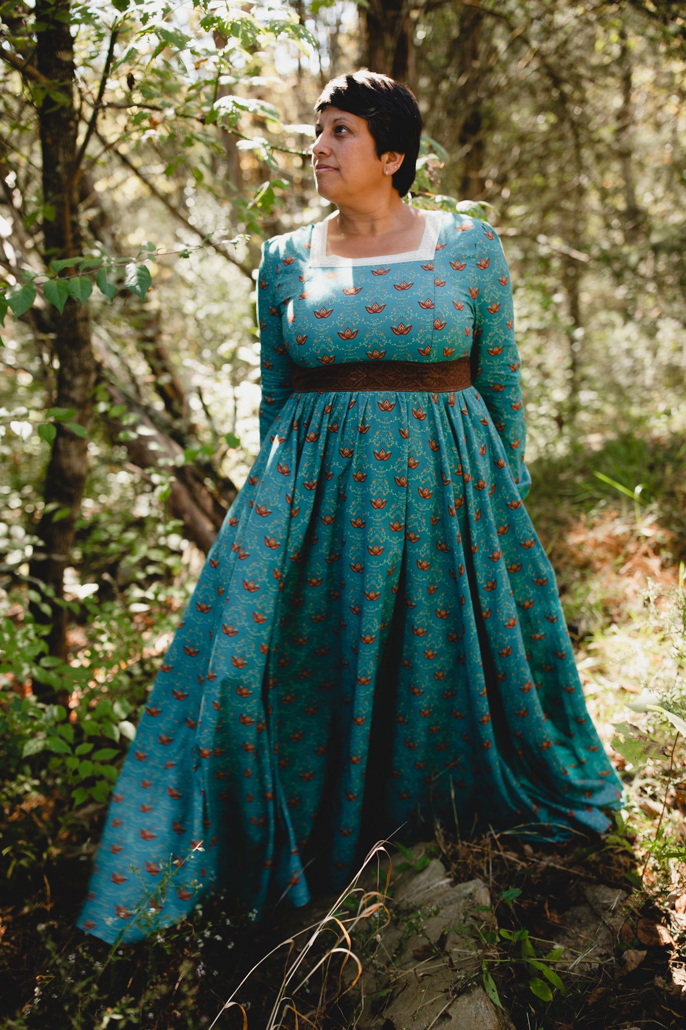 Woman in modest nursing teal dress with belt