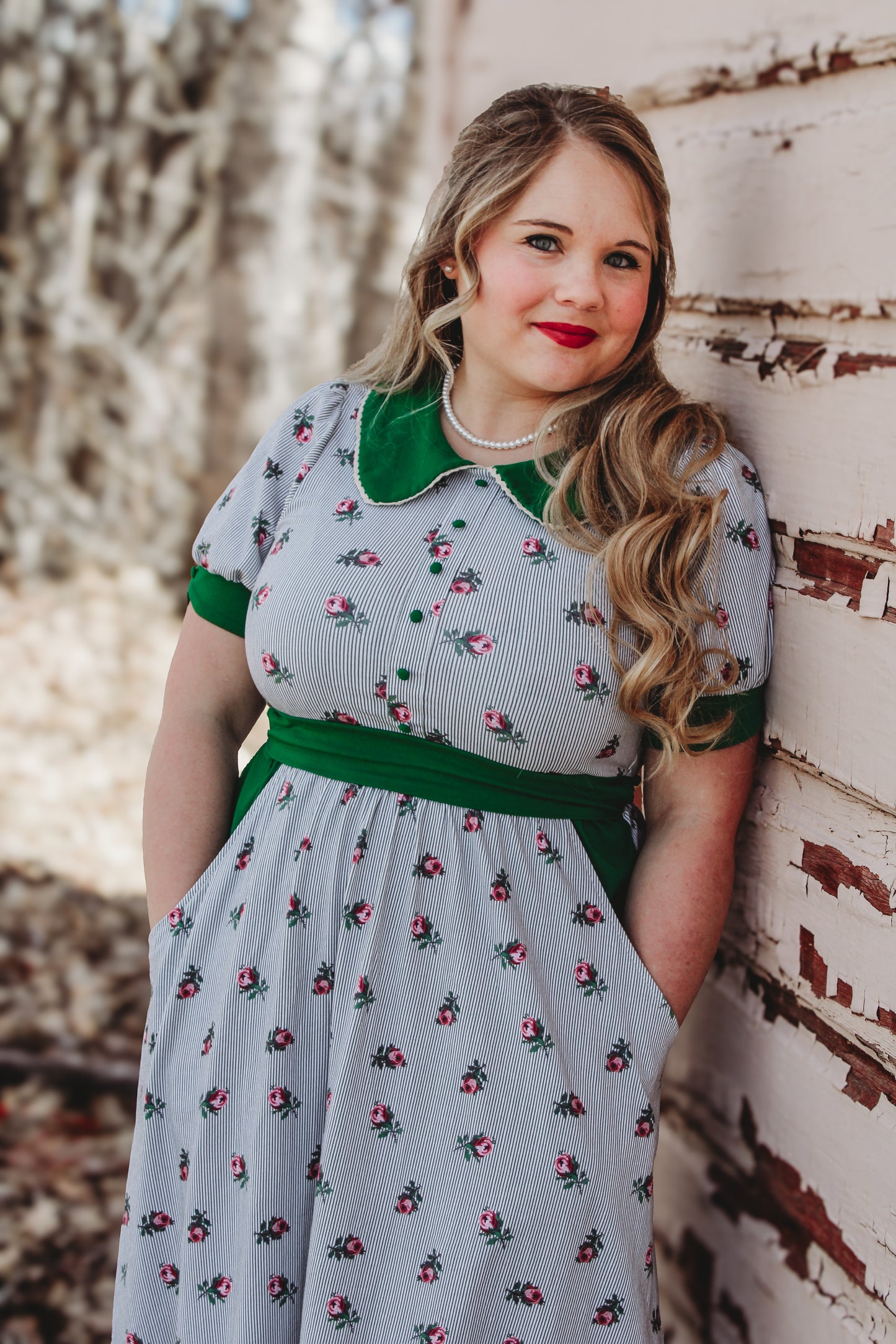 woman wearing a green and white striped modest nursing dress