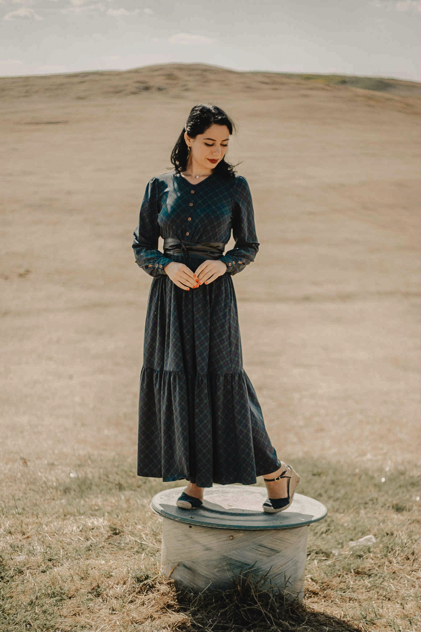 Woman in modest nursing dark green dress outdoors
