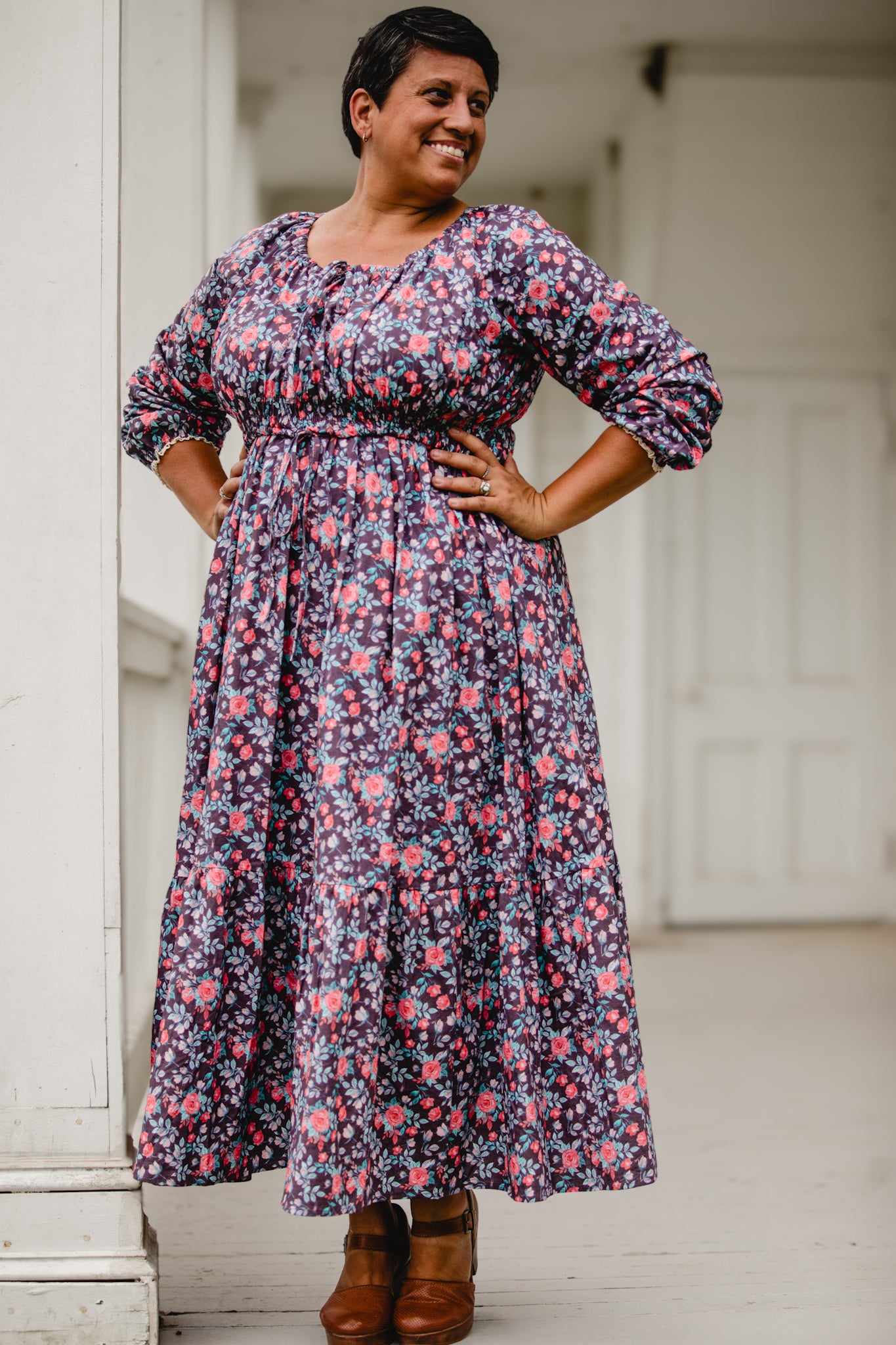 Woman in modest nursing floral dress on porch
