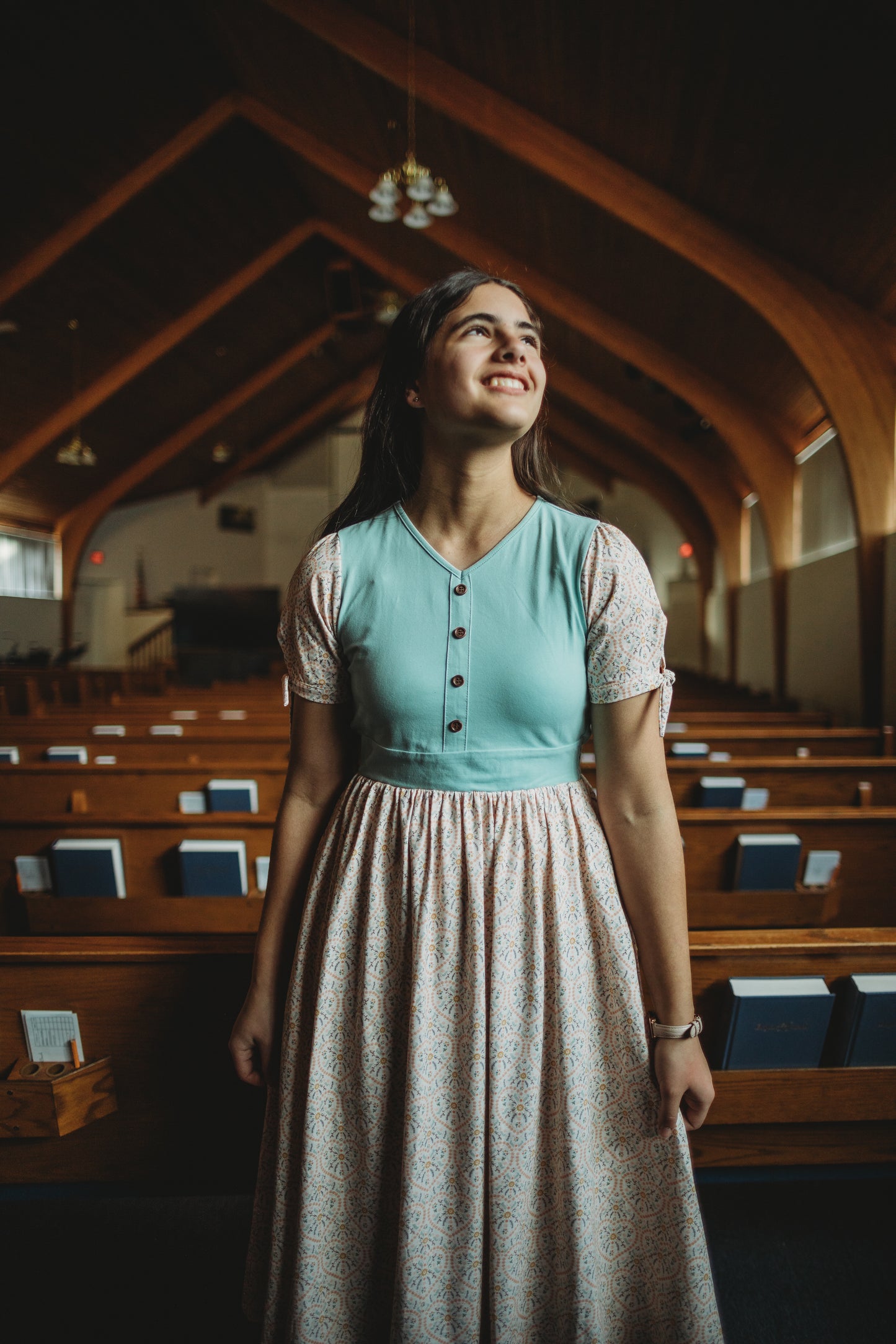 A woman wearing a vintage style modest nursing dress.