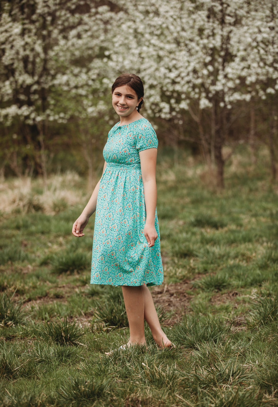 Young girl wearing a modest green dress