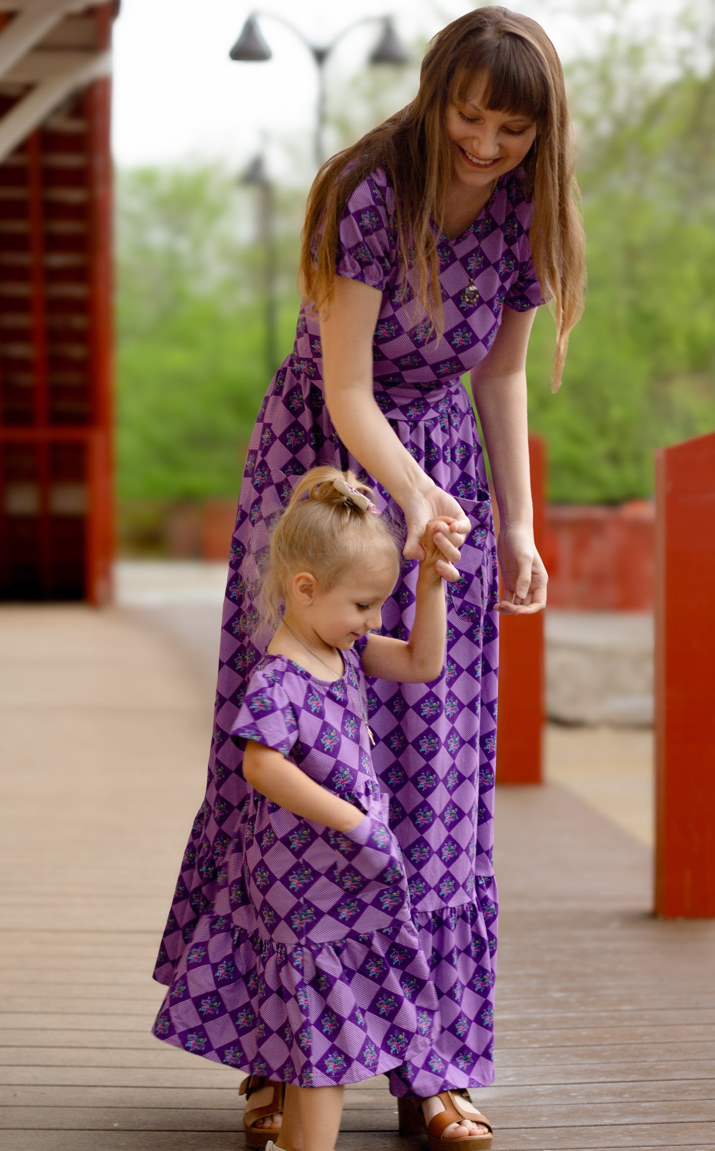 Woman in a purple checkered modest nursing dress.