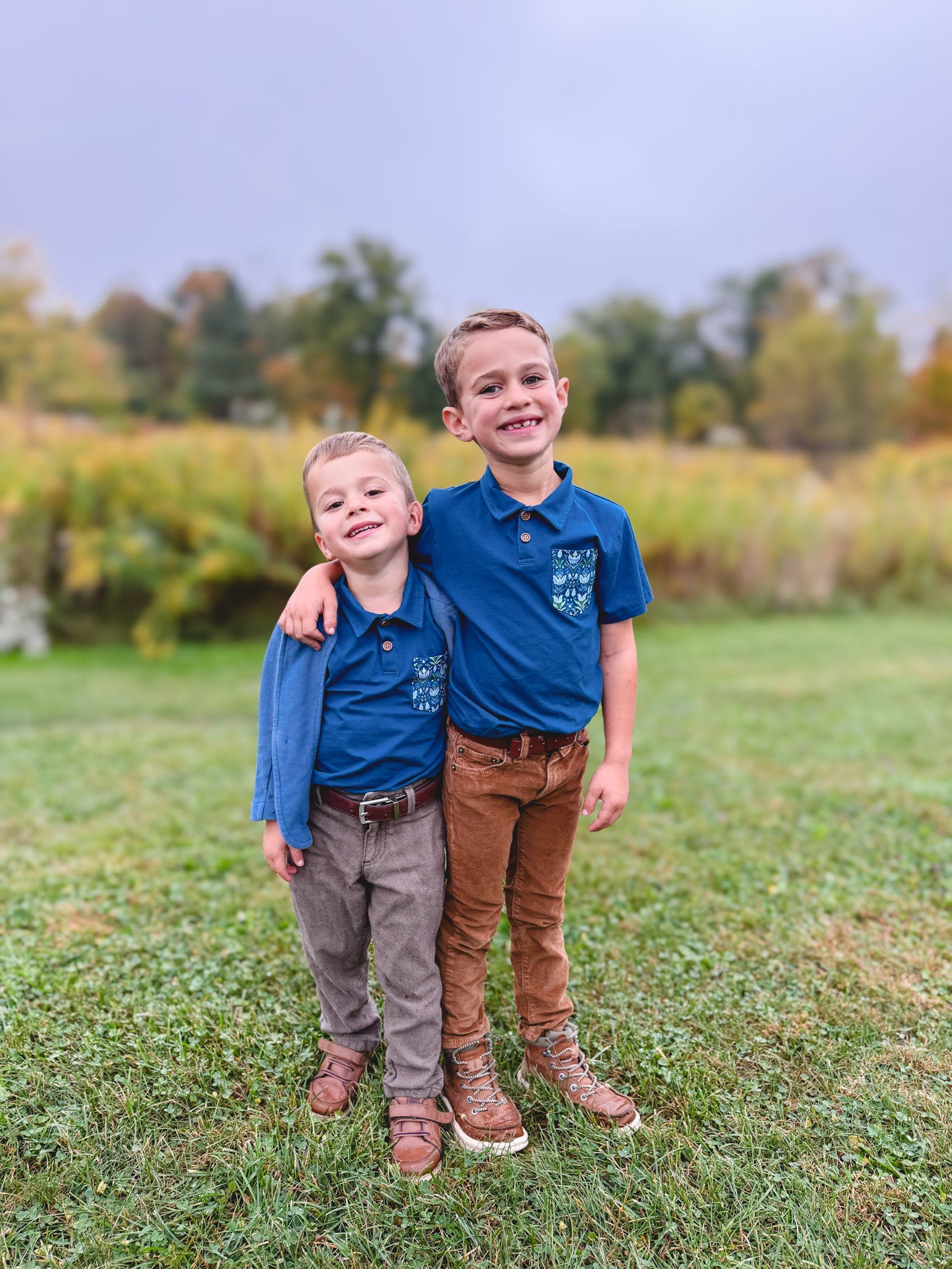 Two boys wearing matching blue Nordic Snowdrop polos