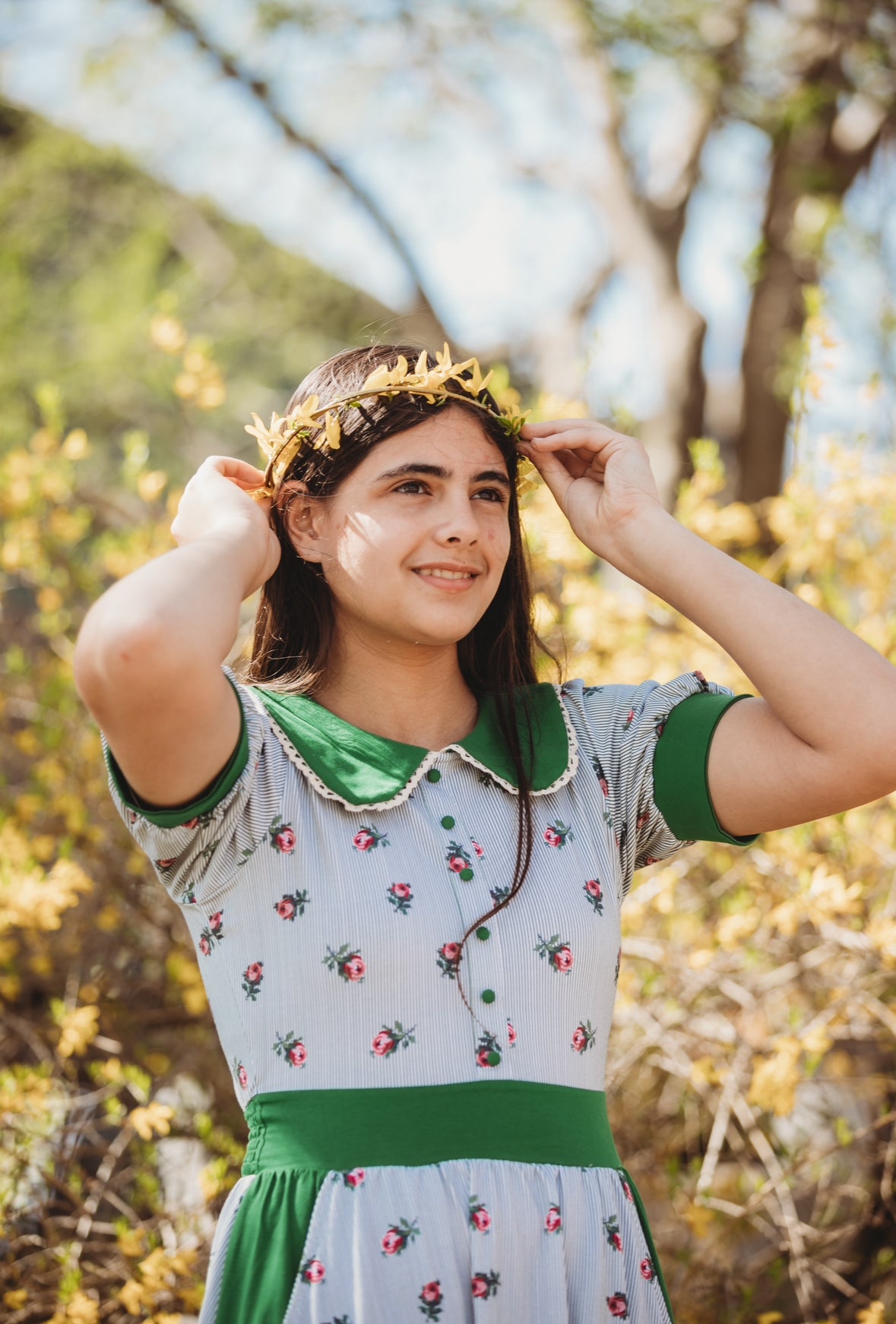 woman wearing a green and white striped modest nursing dress