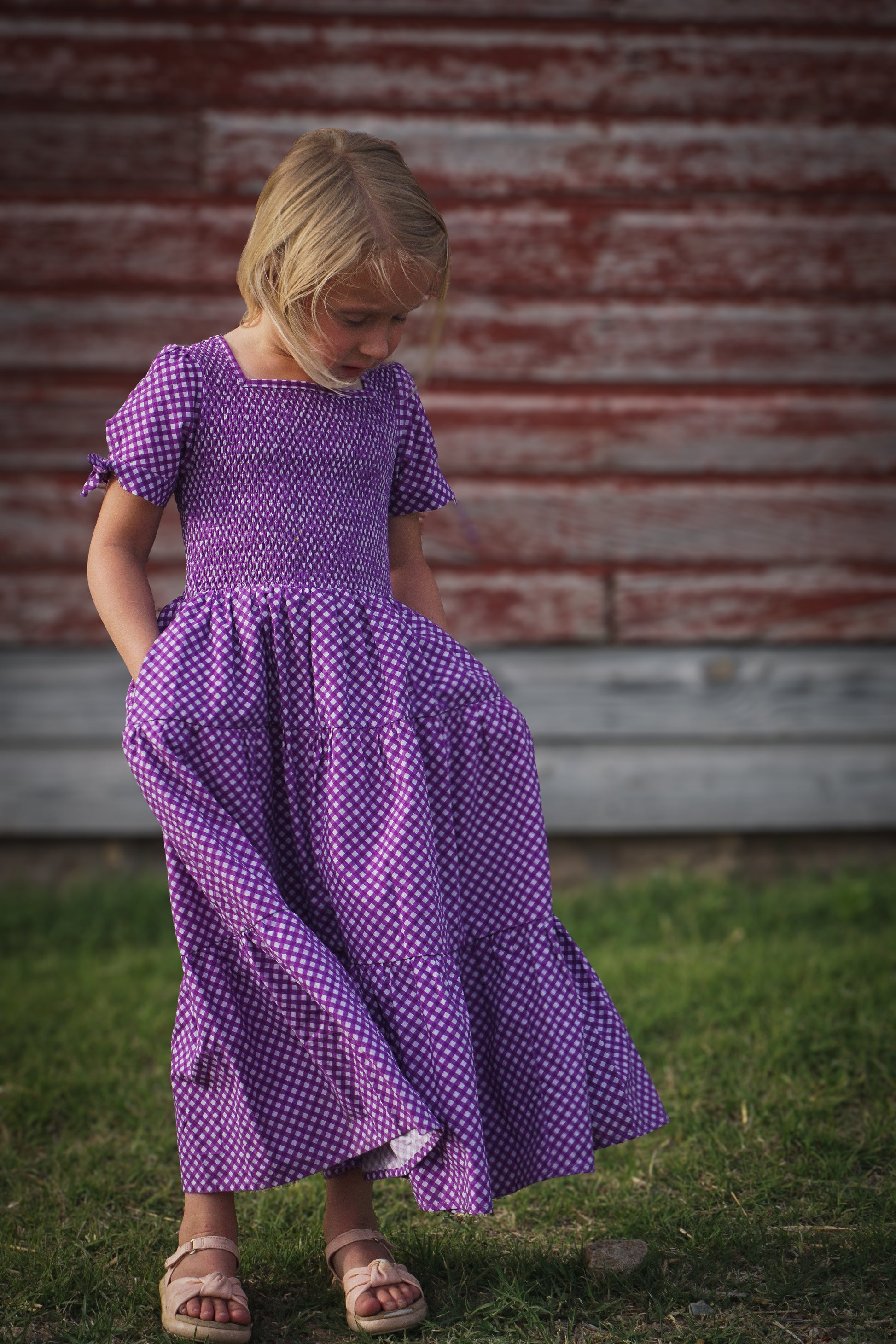 Young girl wearing a modest purple dress