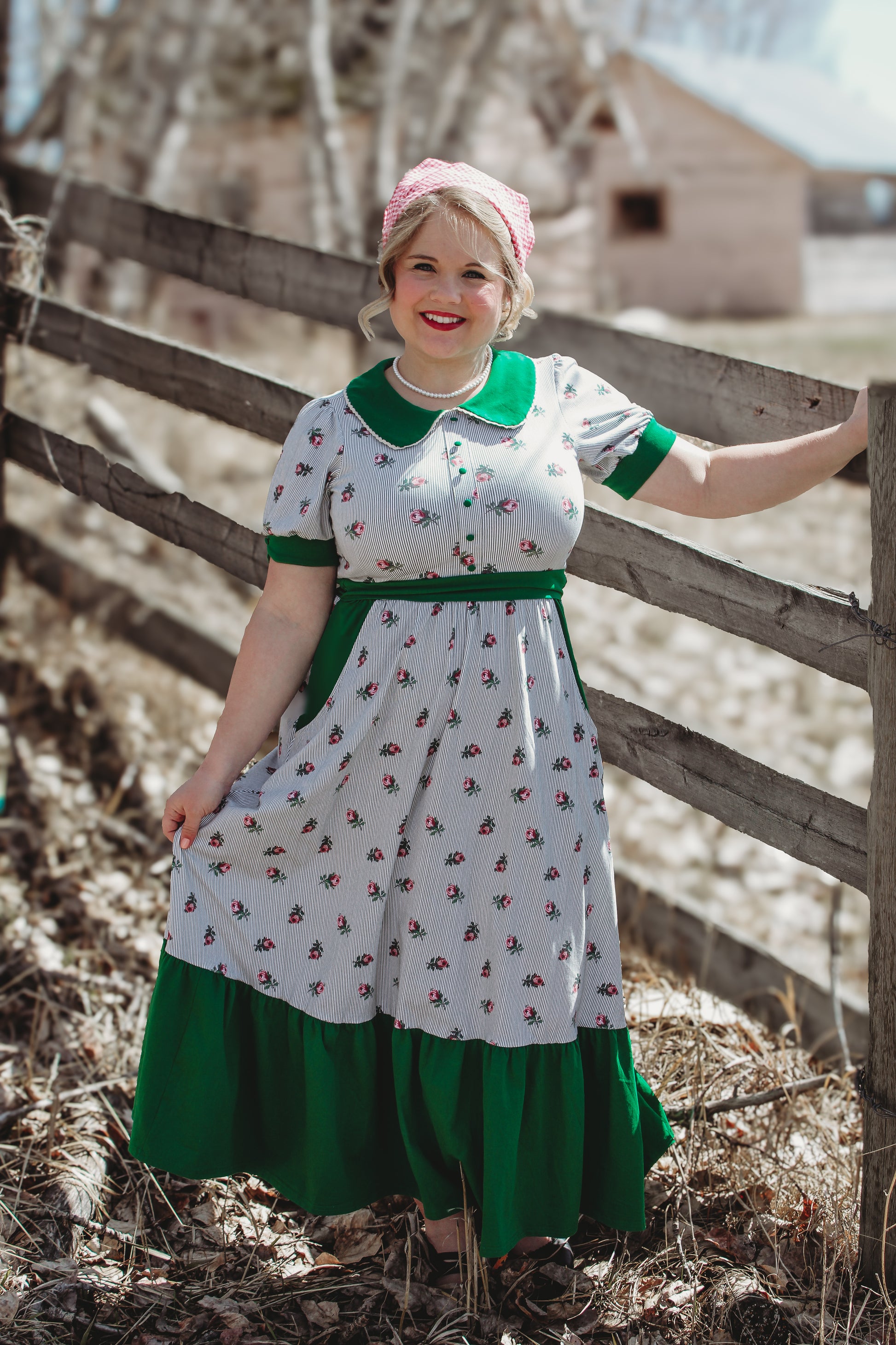 woman wearing a green and white striped modest nursing dress