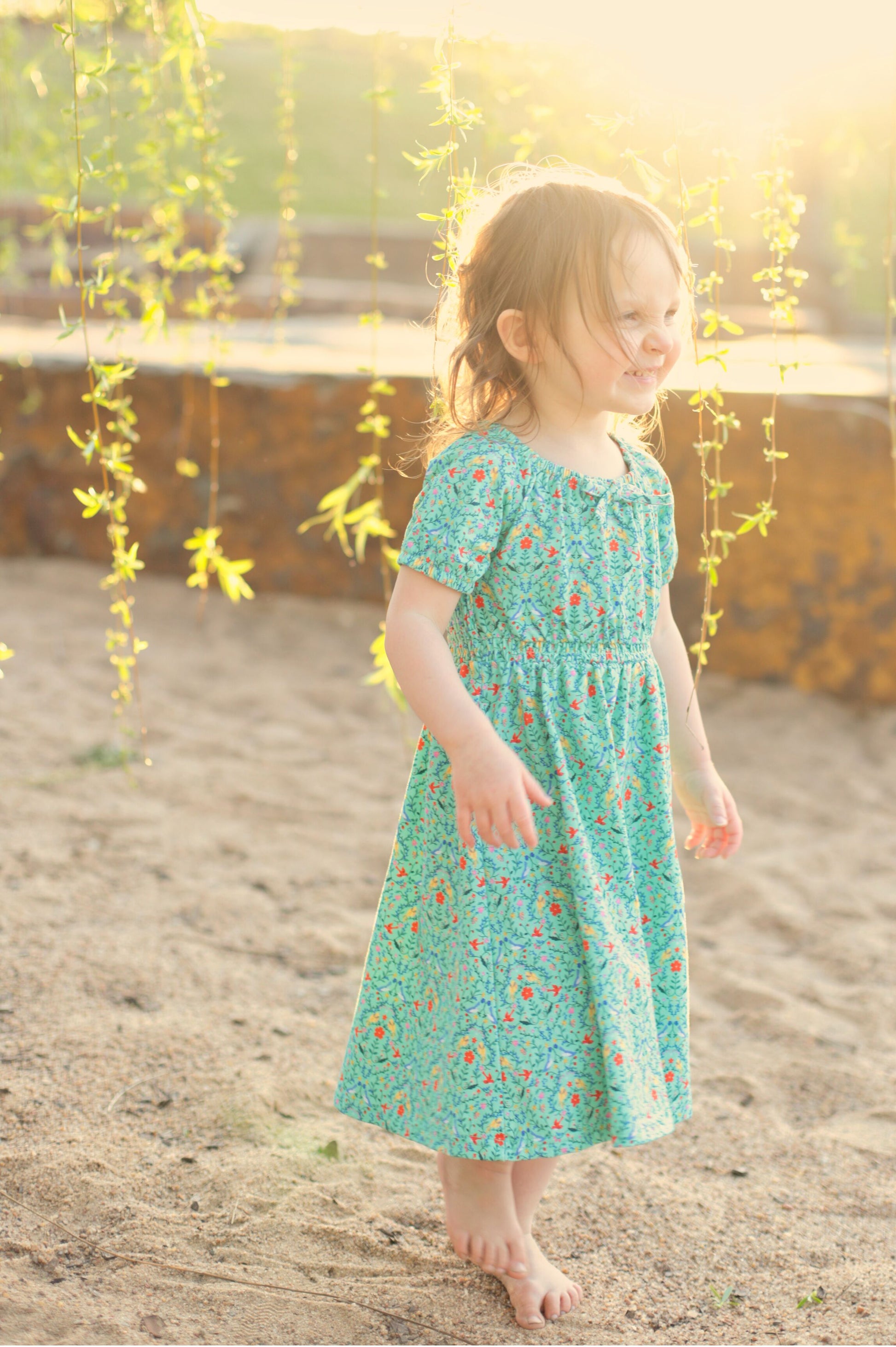 Young girl wearing a modest green dress