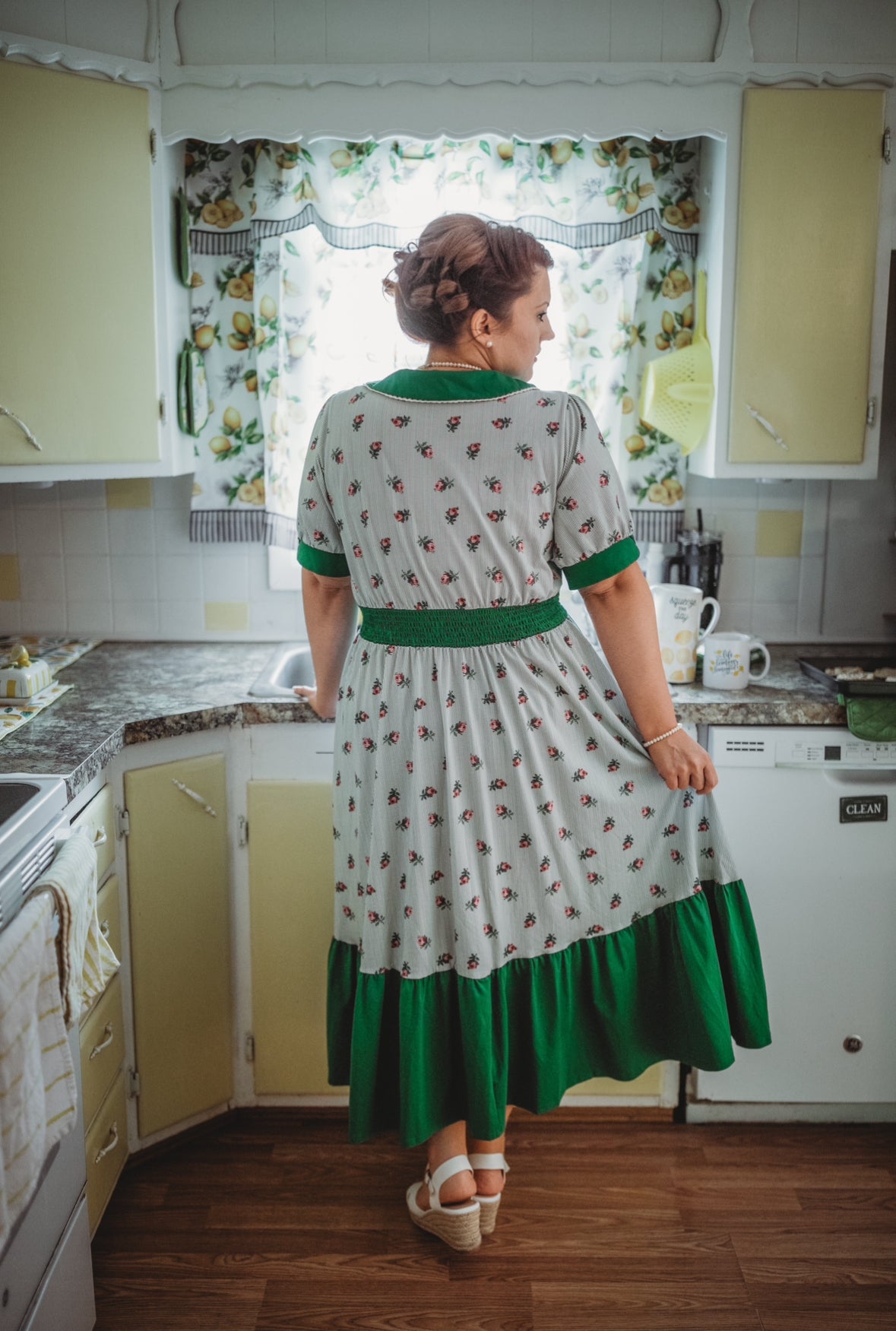 woman wearing a green and white striped modest nursing dress