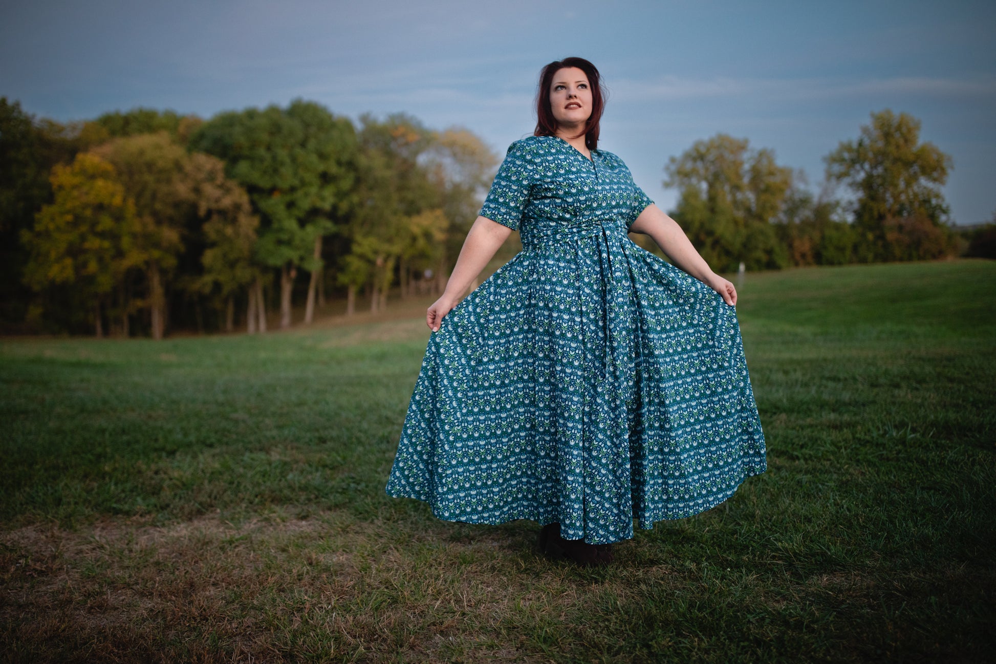 Woman in modest nursing dress in grassy field