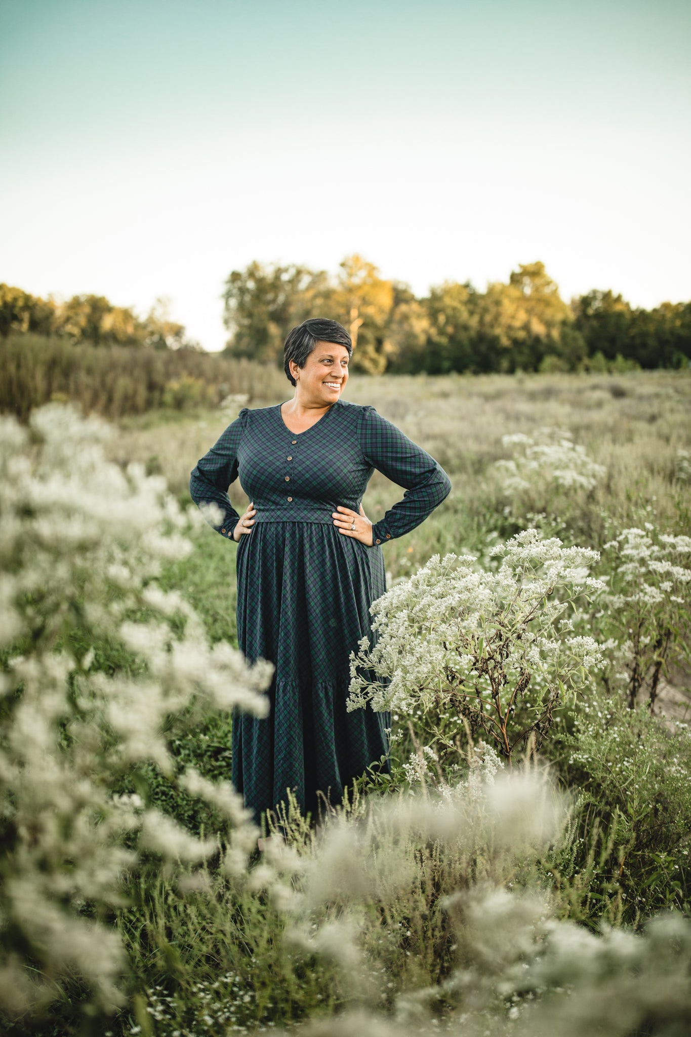 Woman in modest nursing dress white flowers field