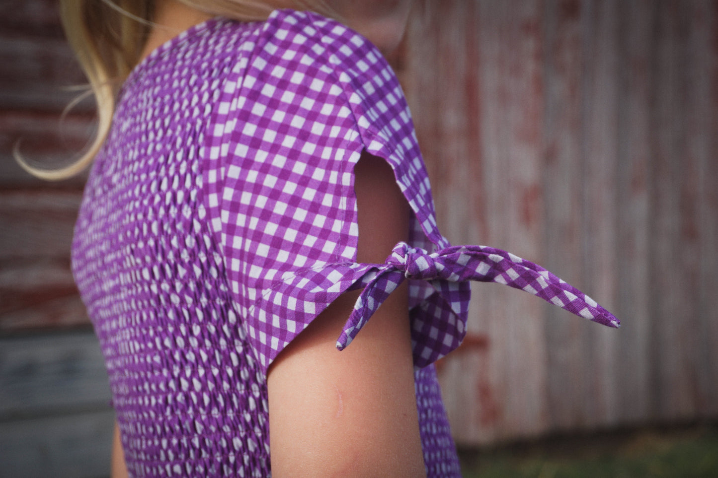 Young girl wearing a modest purple dress
