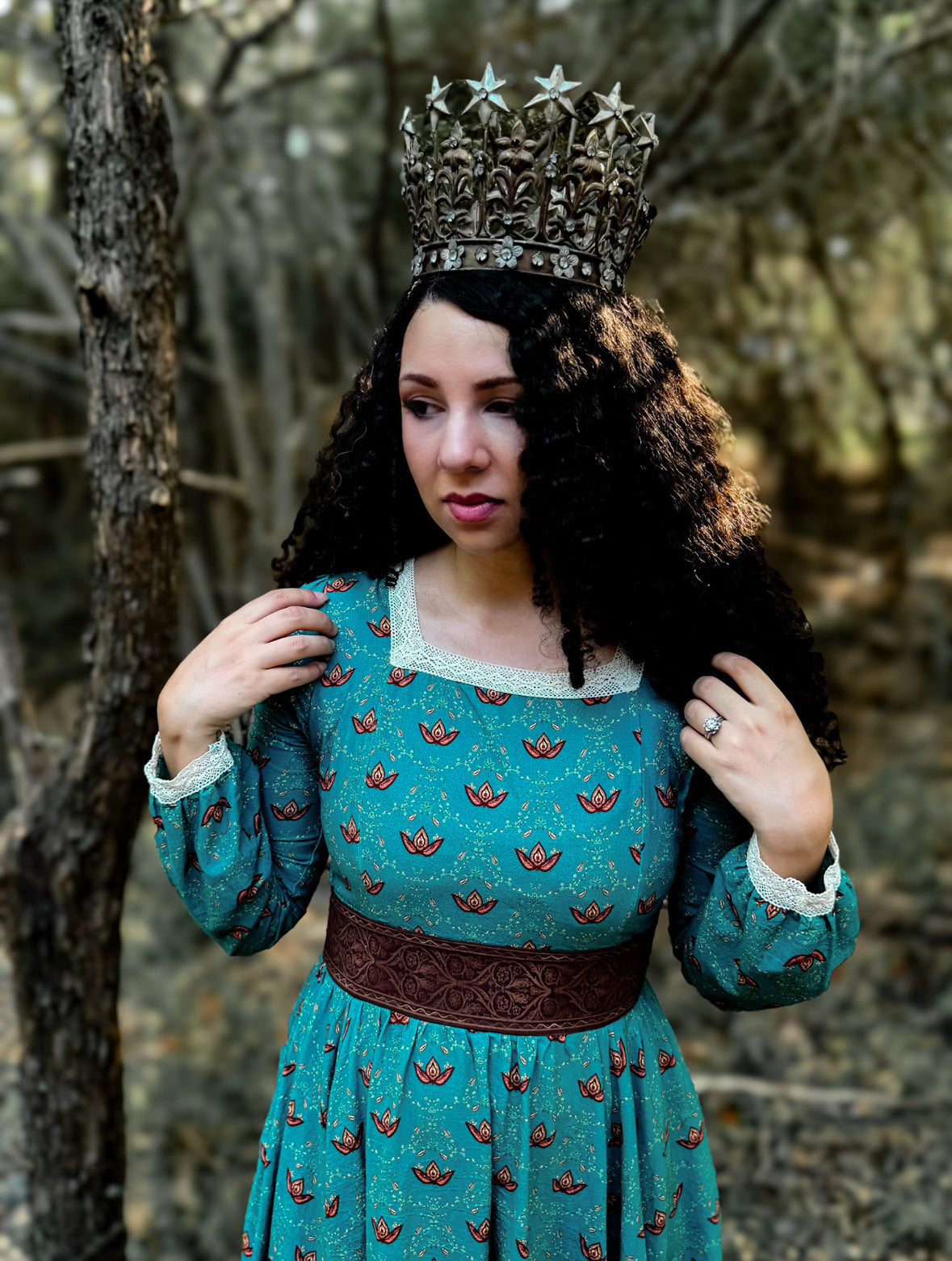 Woman in modest nursing teal dress with crown