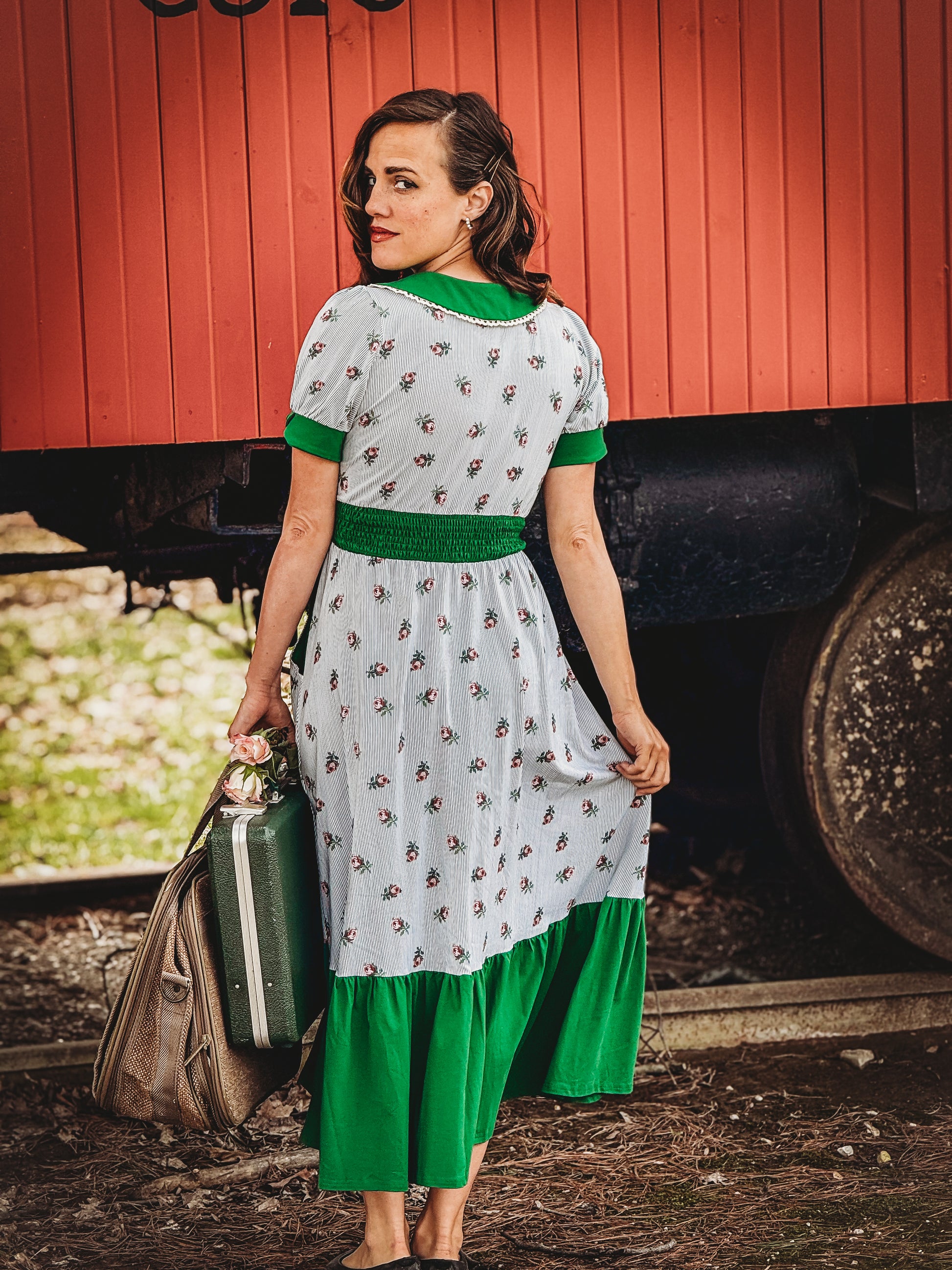 woman wearing a green and white striped modest nursing dress