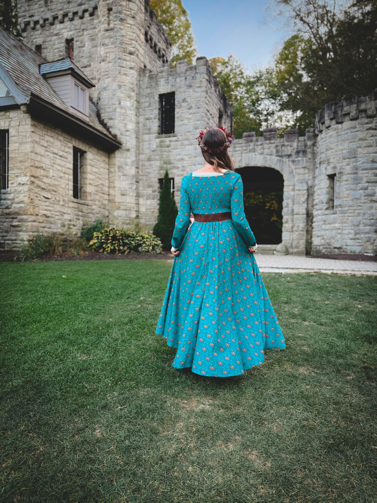 Woman in modest nursing blue dress at castle