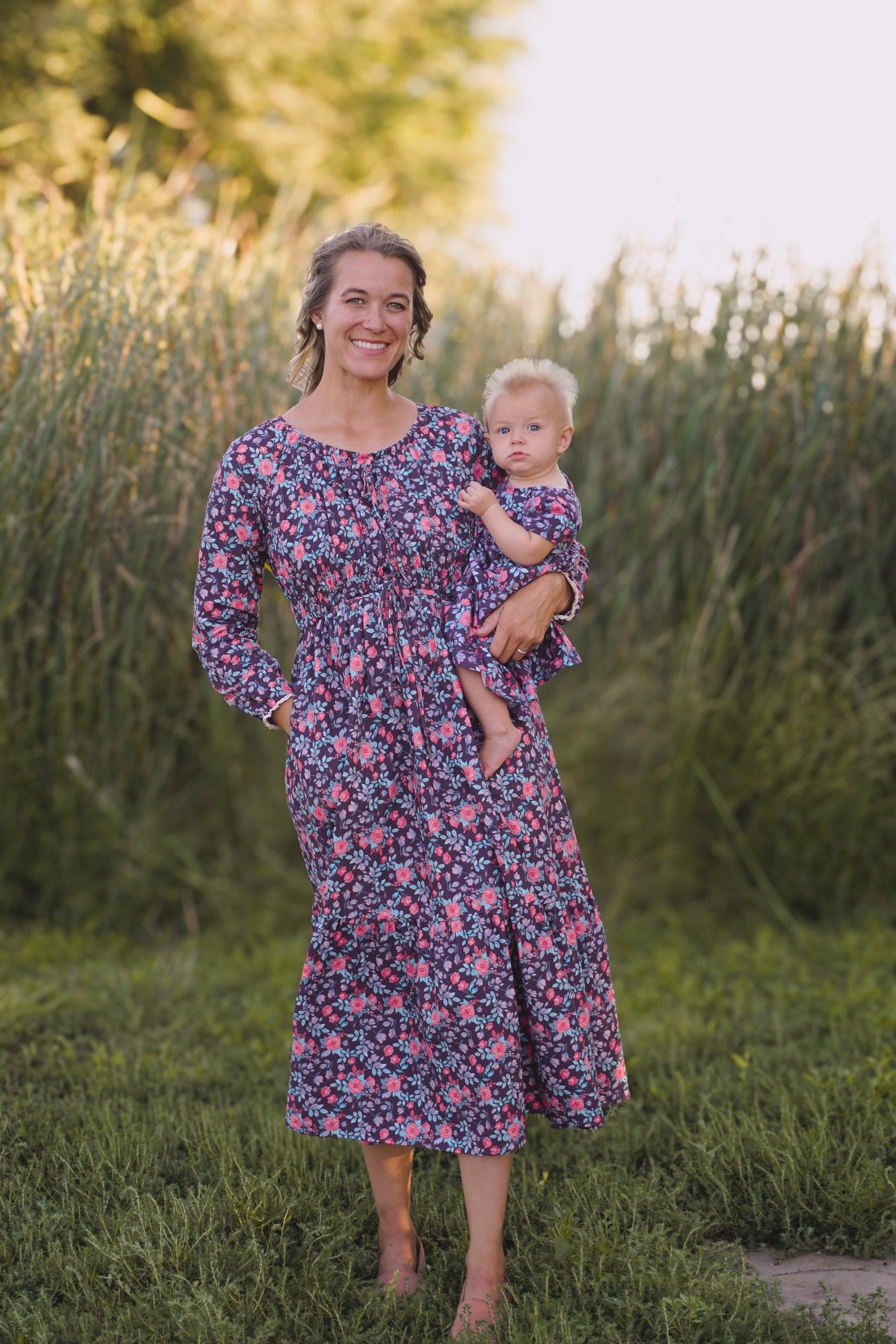 Woman in modest nursing dress holding baby