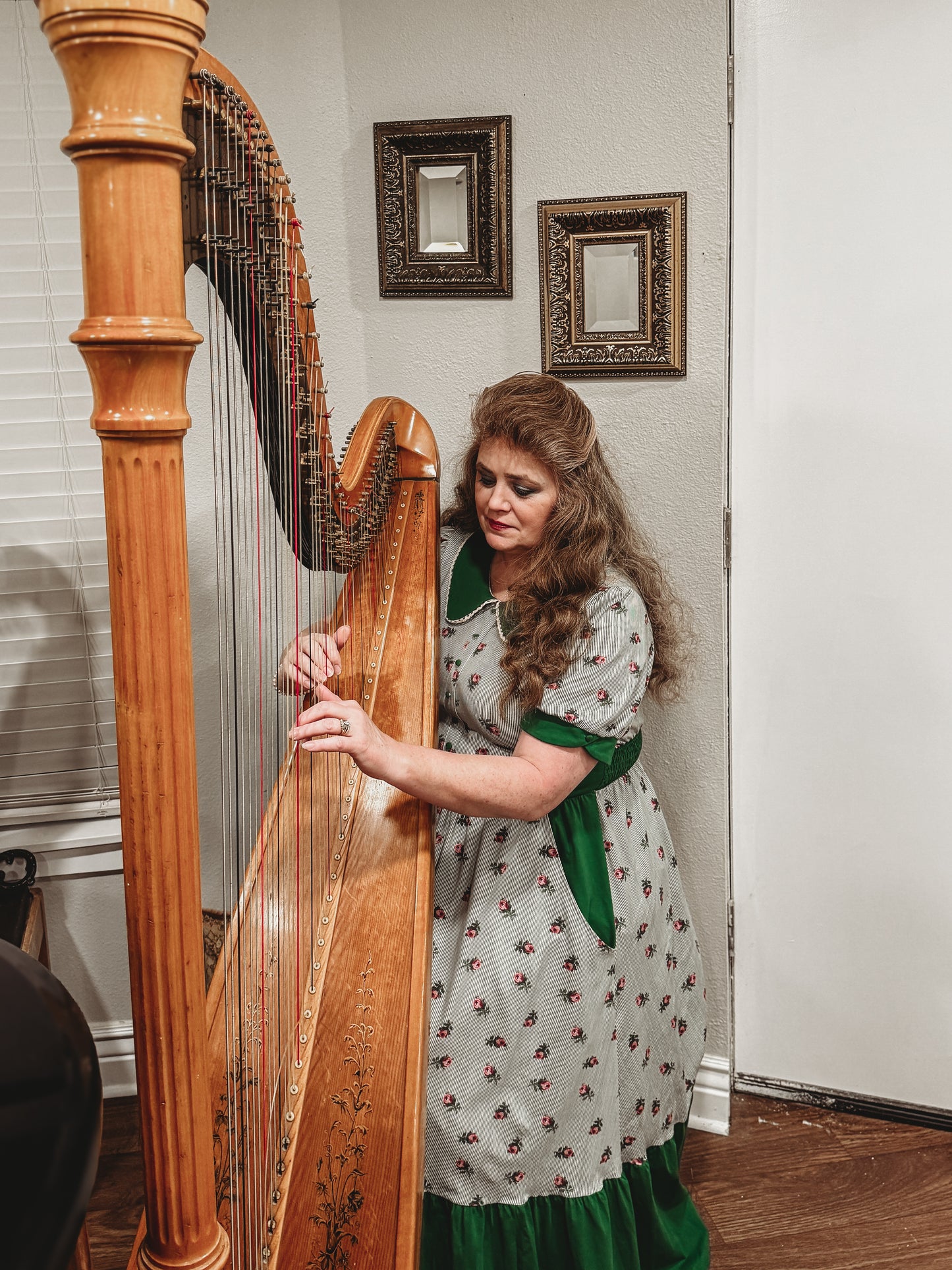 woman wearing a green and white striped modest nursing dress