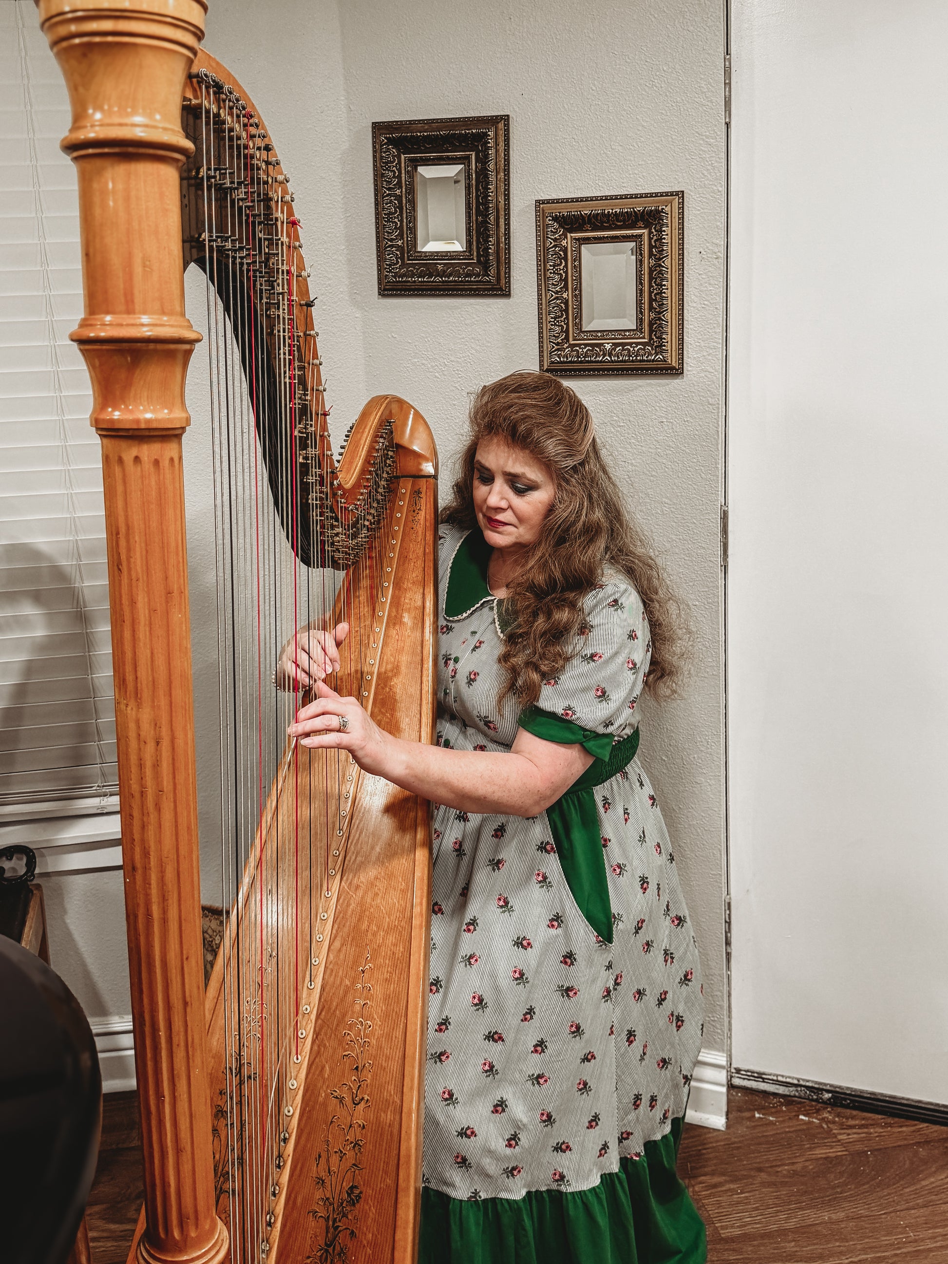 woman wearing a green and white striped modest nursing dress