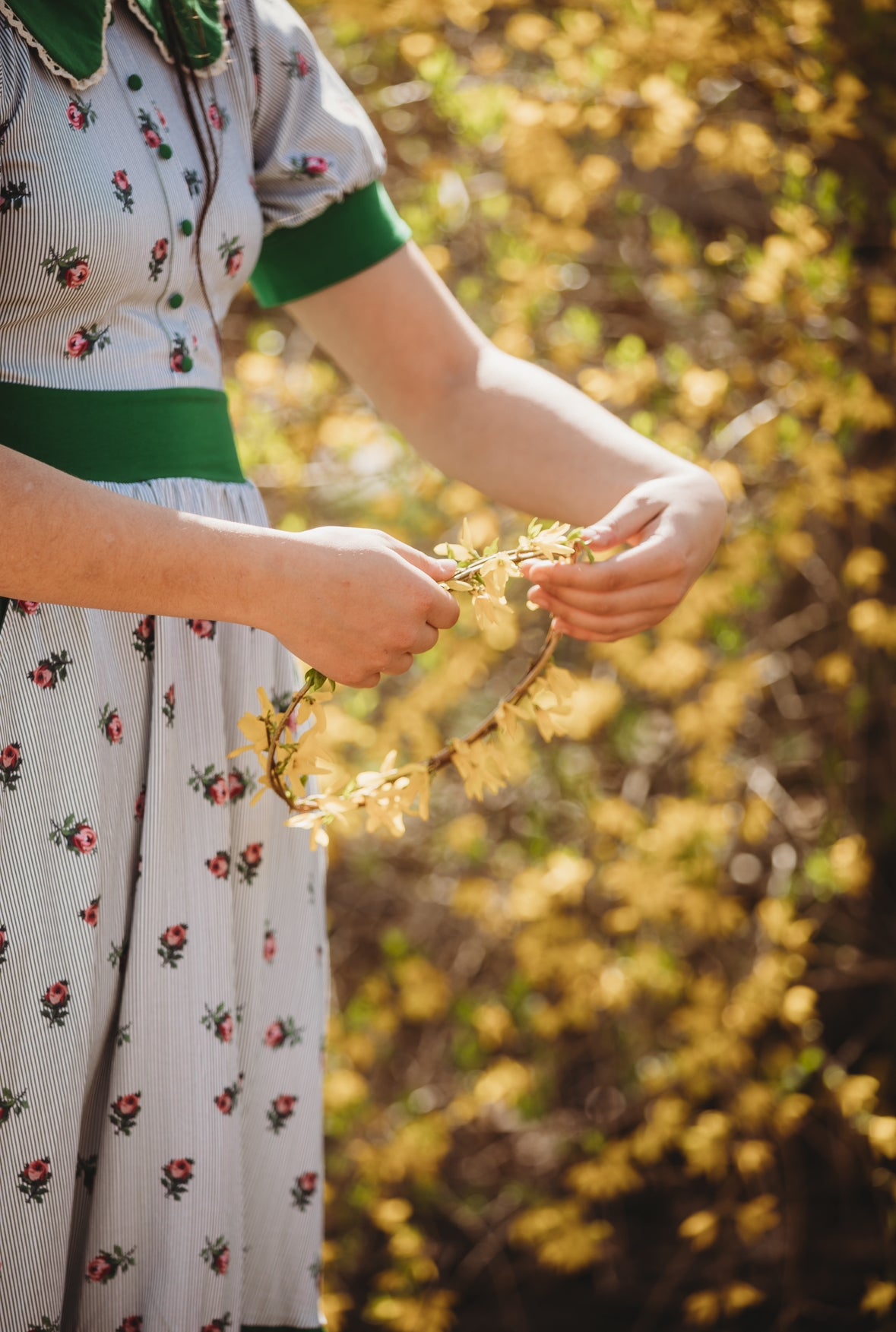 woman wearing a green and white striped modest nursing dress