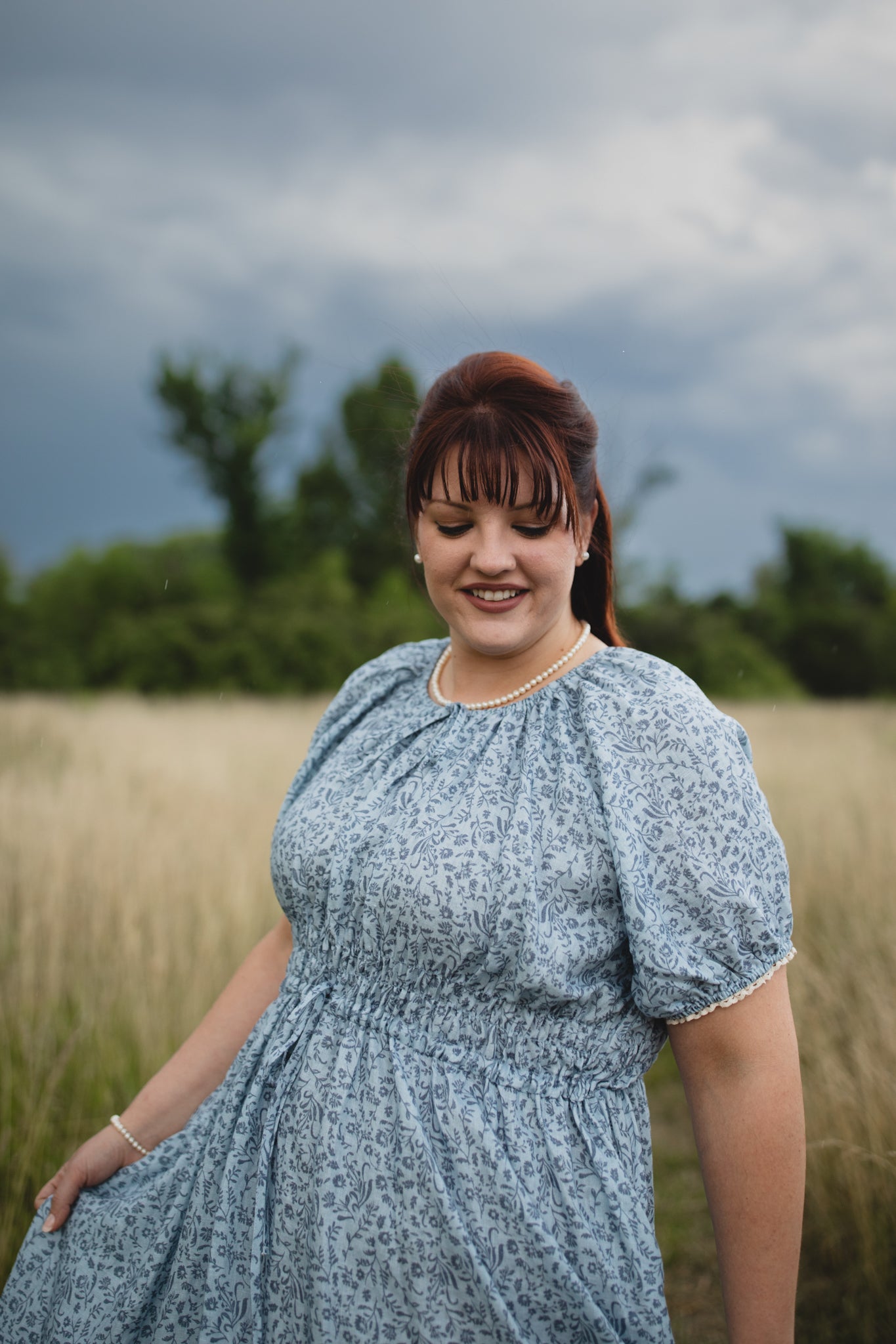 woman in a modest blue nursing dress