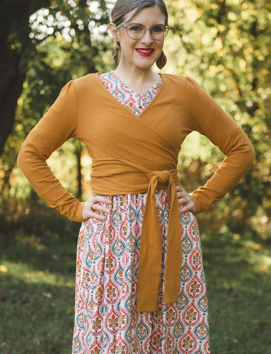 Woman in modest nursing-friendly wrap and patterned skirt