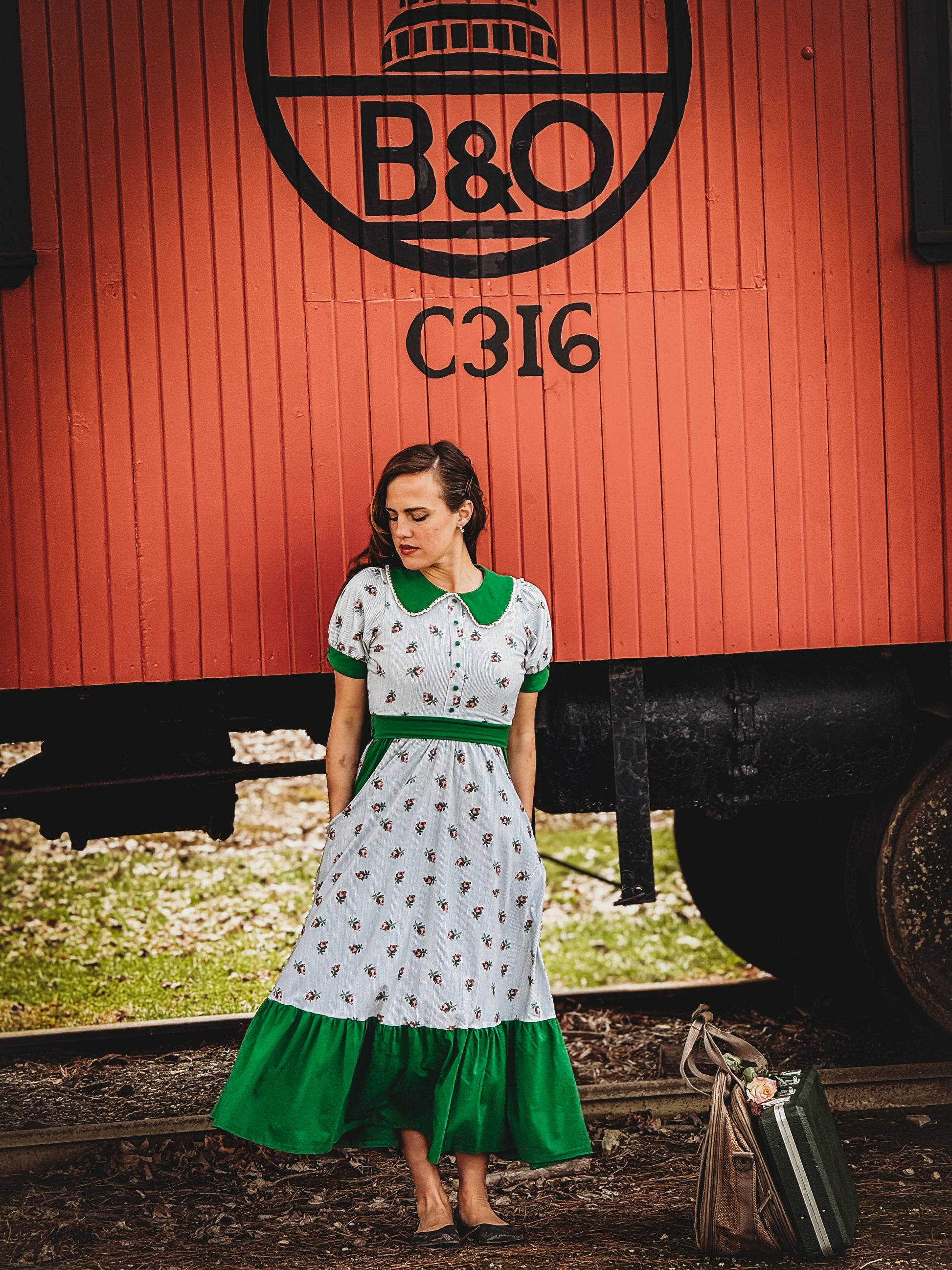 woman wearing a green and white striped modest nursing dress