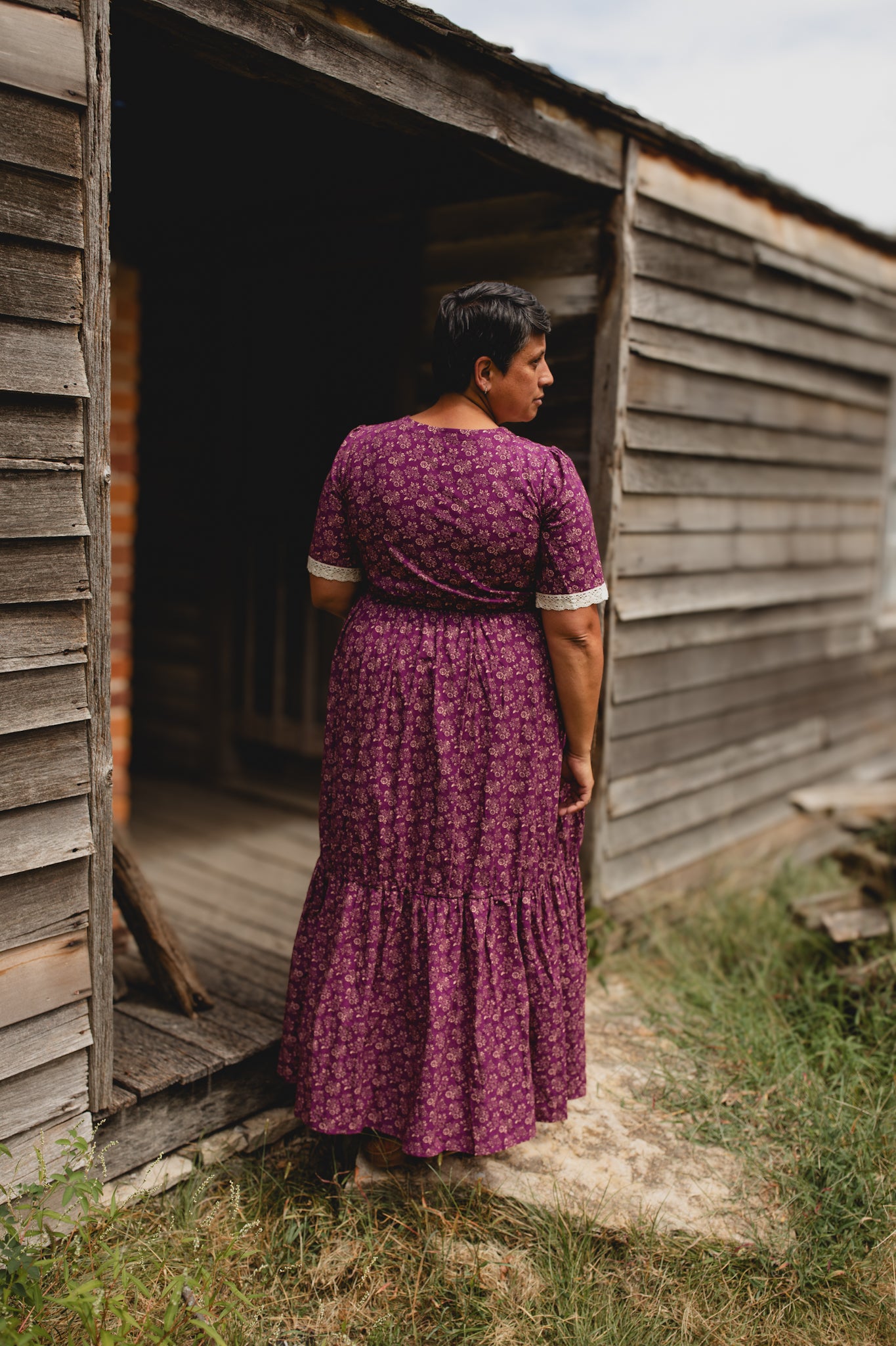 Woman wearing modest purple nursing dress outdoors