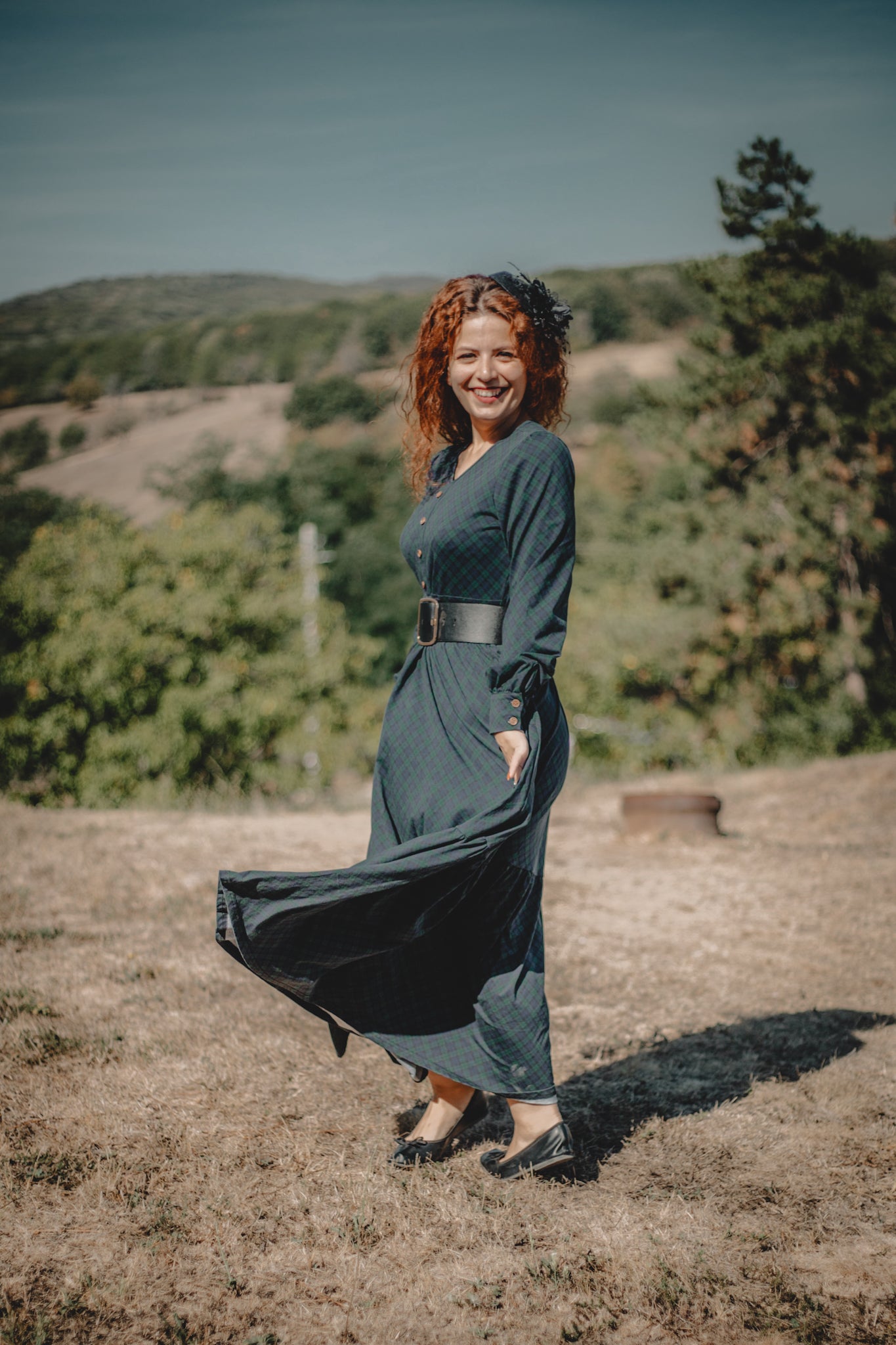 Woman in modest nursing dark dress outdoors greenery