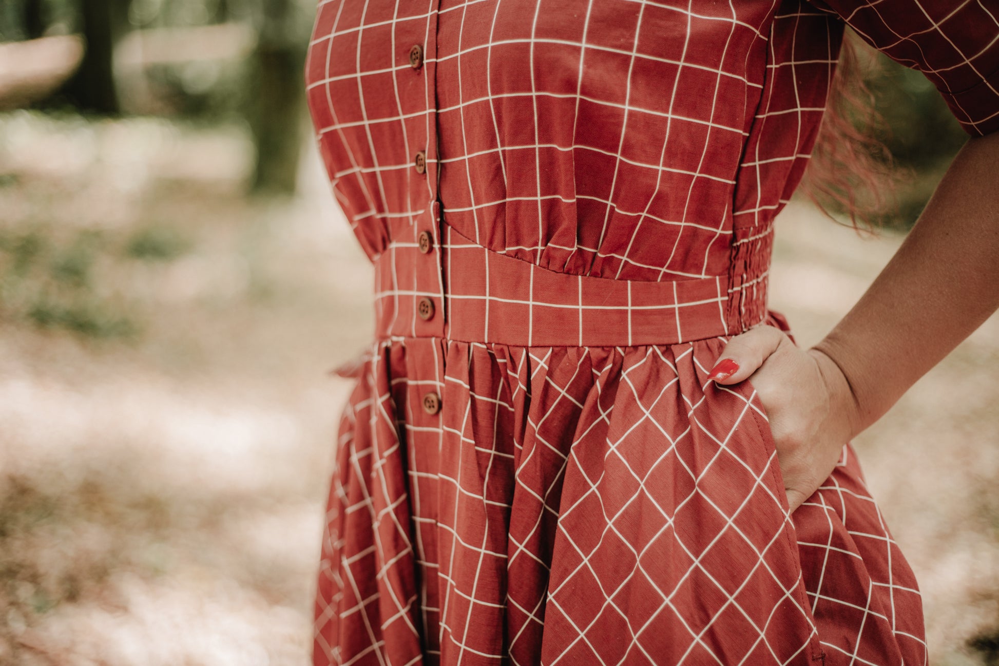 Woman in modest nursing checkered dress outdoors