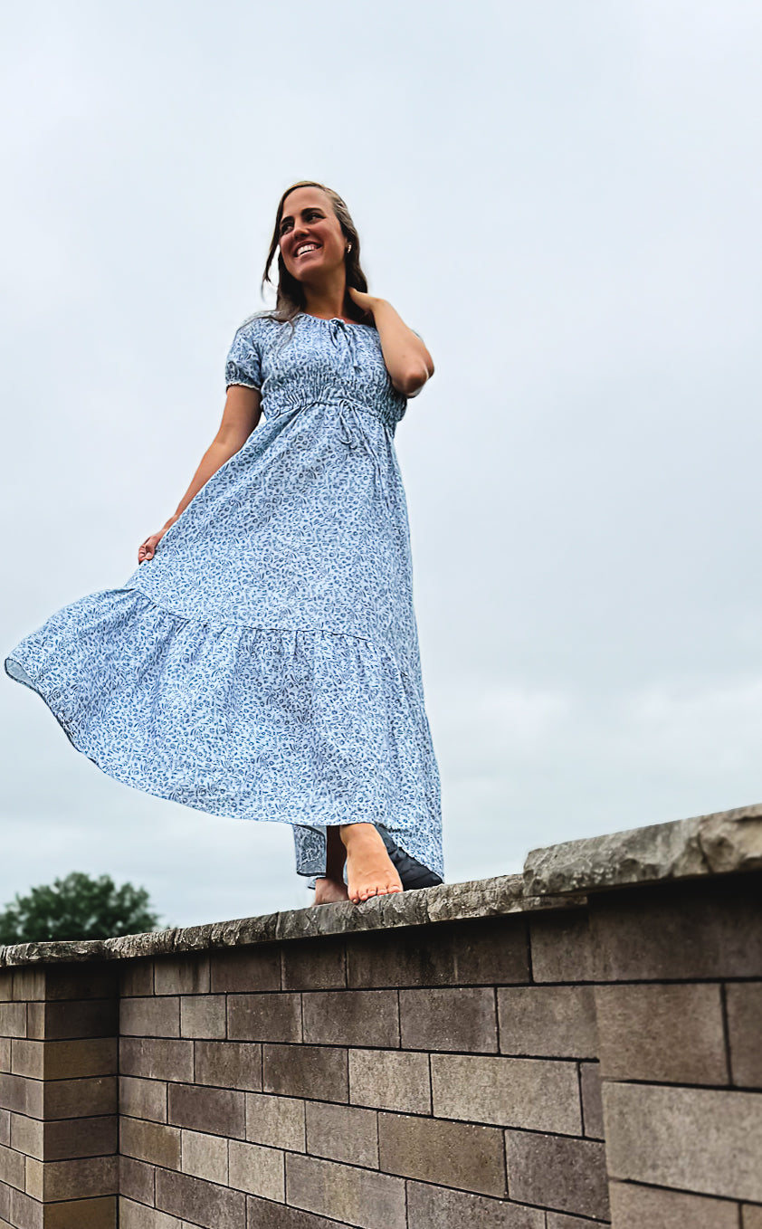 woman in a modest blue nursing dress