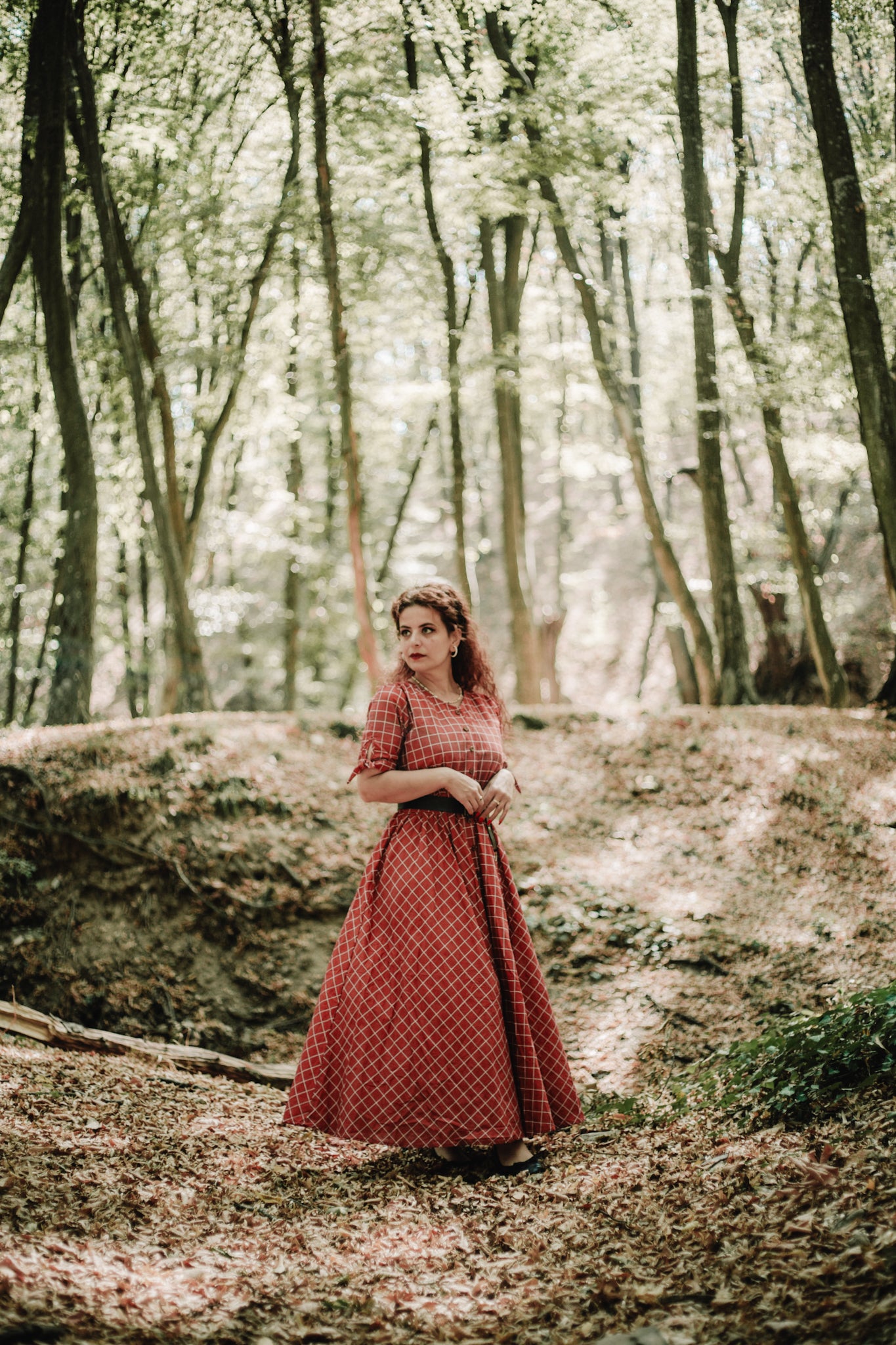 Woman in modest nursing red checkered dress