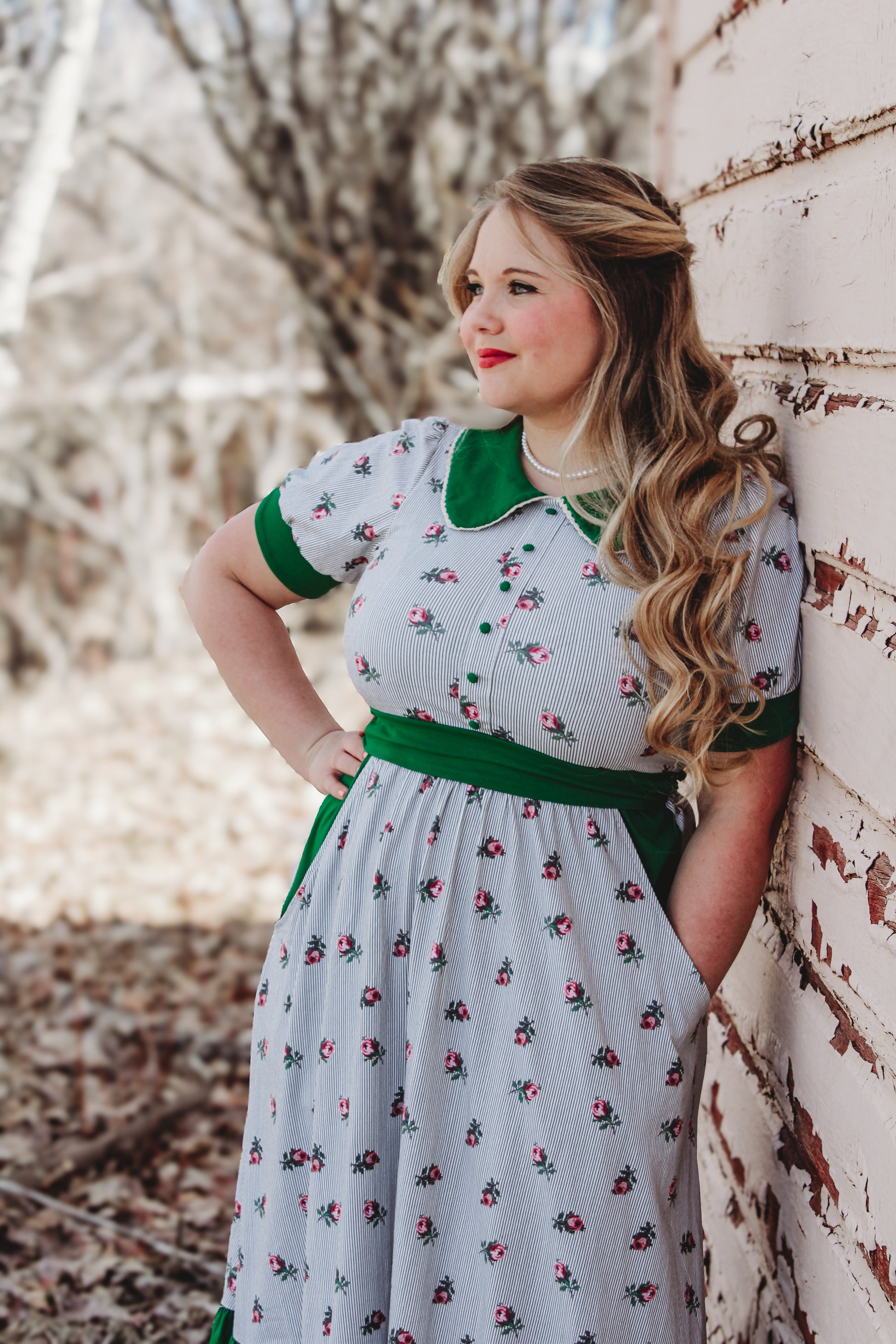 woman wearing a green and white striped modest nursing dress