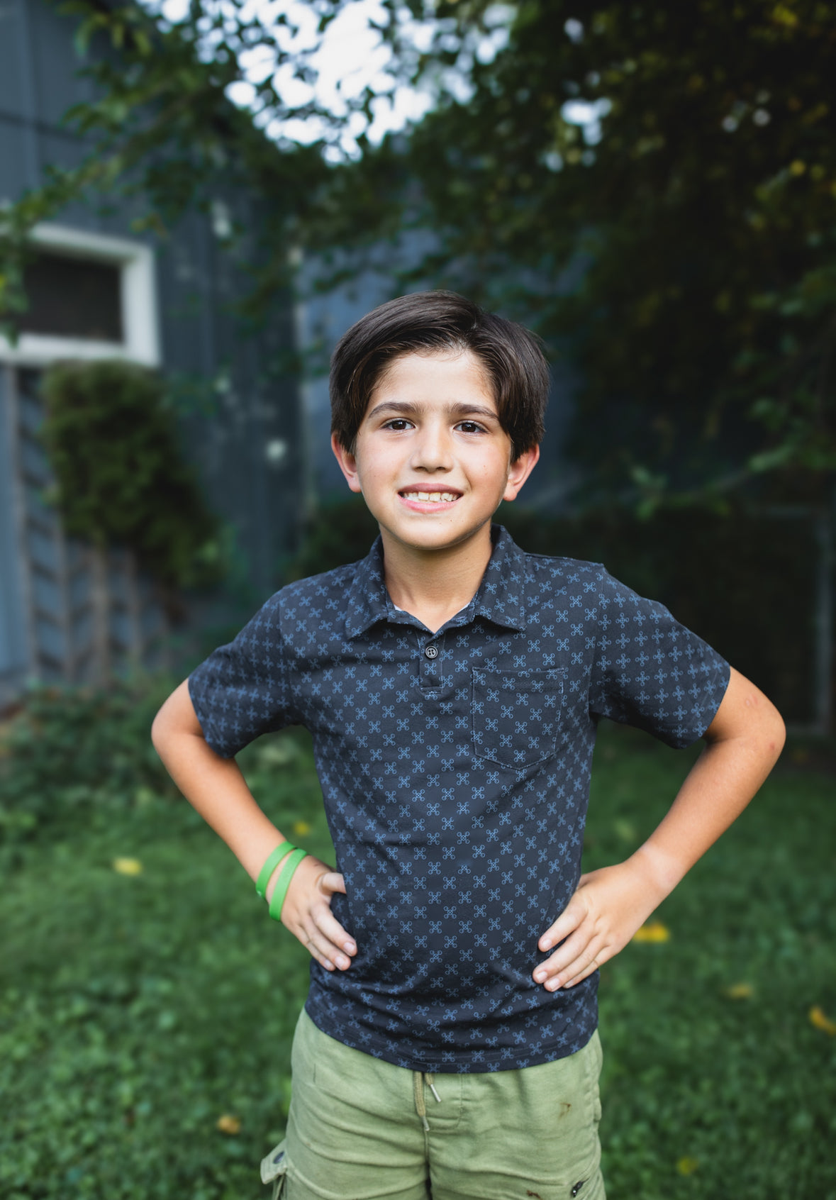 Young boy wearing a dark blue polo shirt
