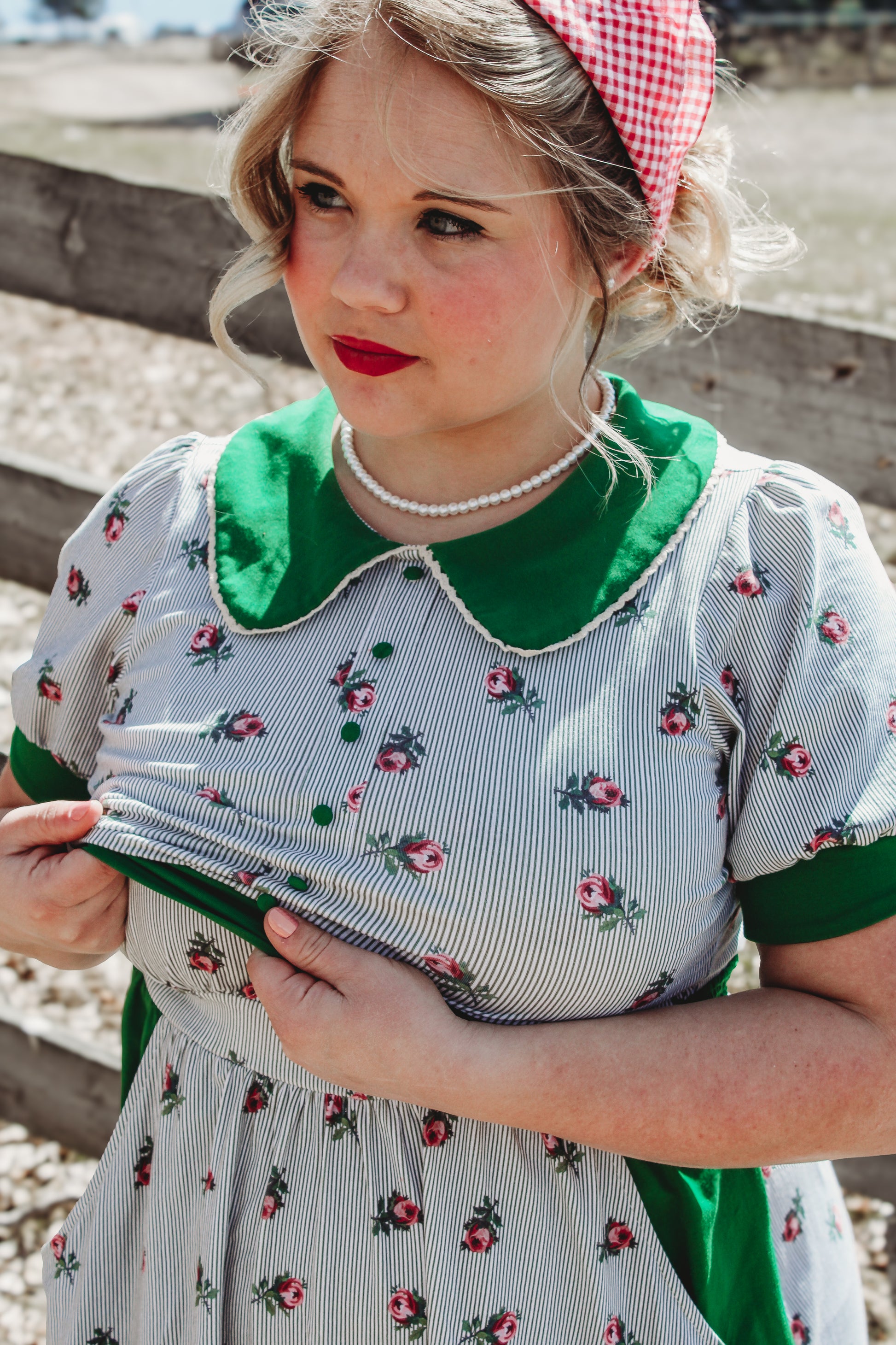 woman wearing a green and white striped modest nursing dress