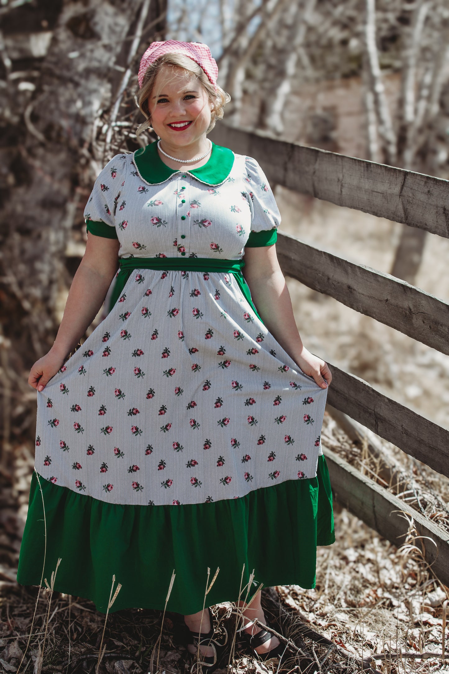 woman wearing a green and white striped modest nursing dress