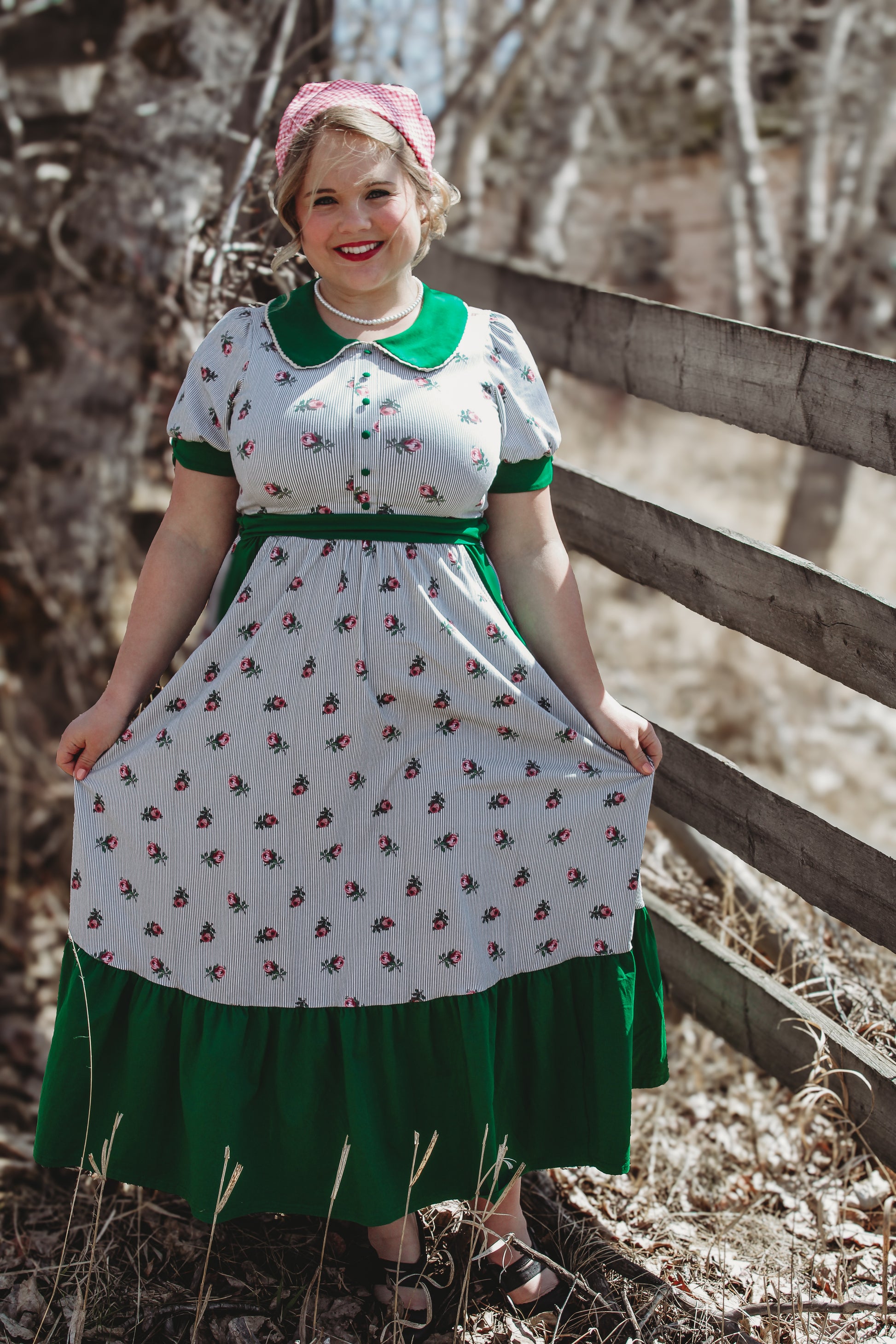 woman wearing a green and white striped modest nursing dress