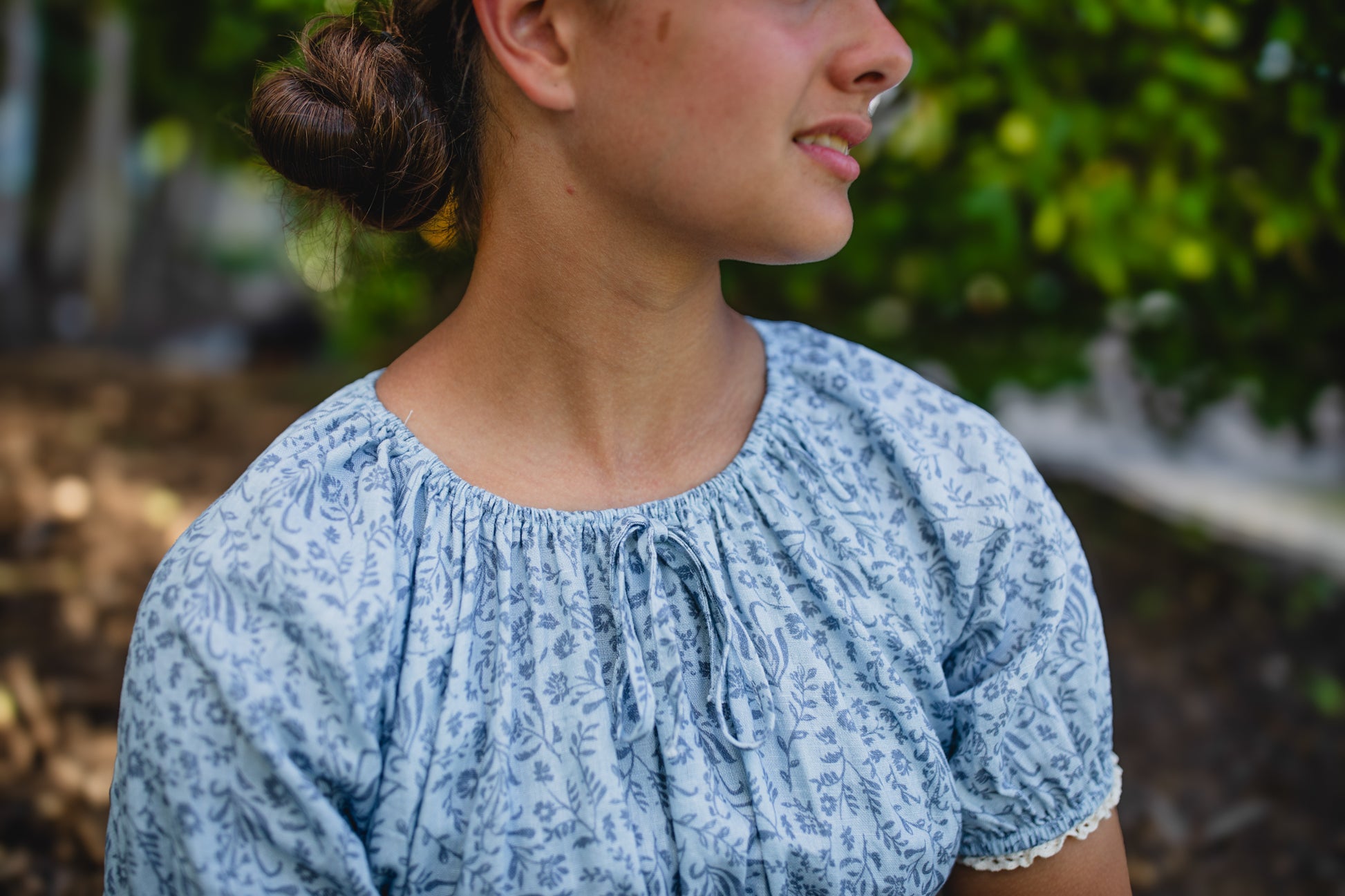 woman in a modest blue nursing dress