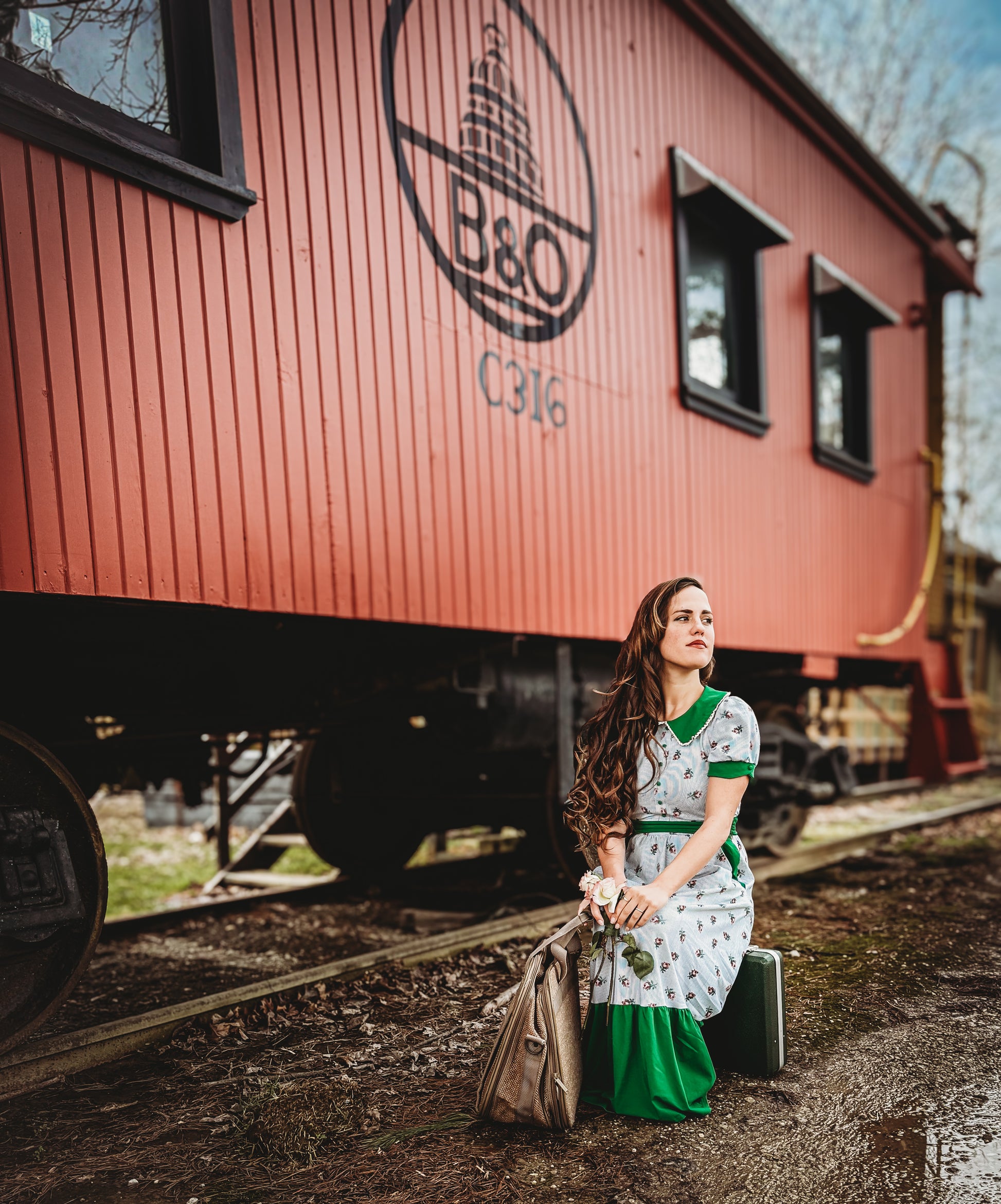 woman wearing a green and white striped modest nursing dress