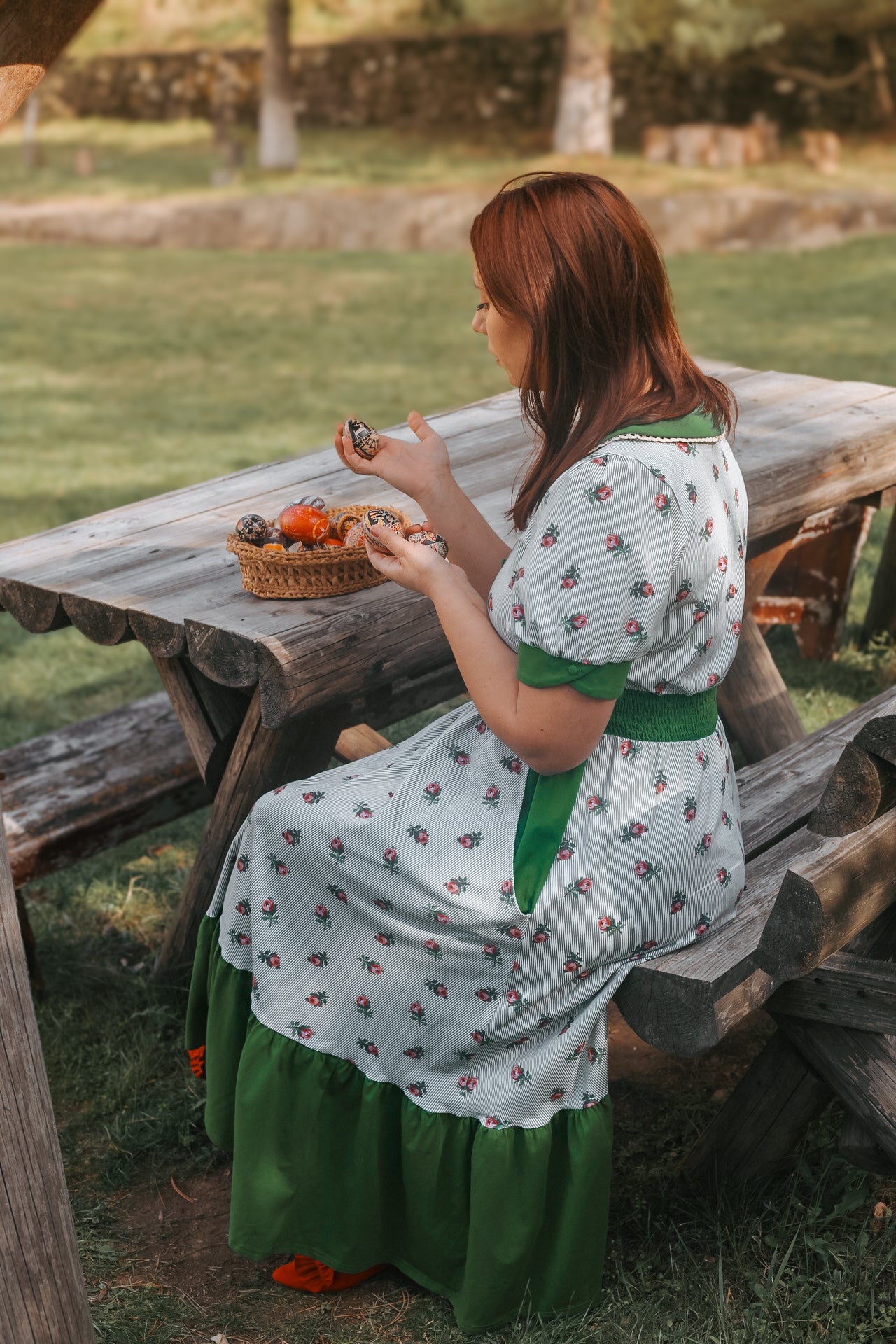 woman wearing a green and white striped modest nursing dress